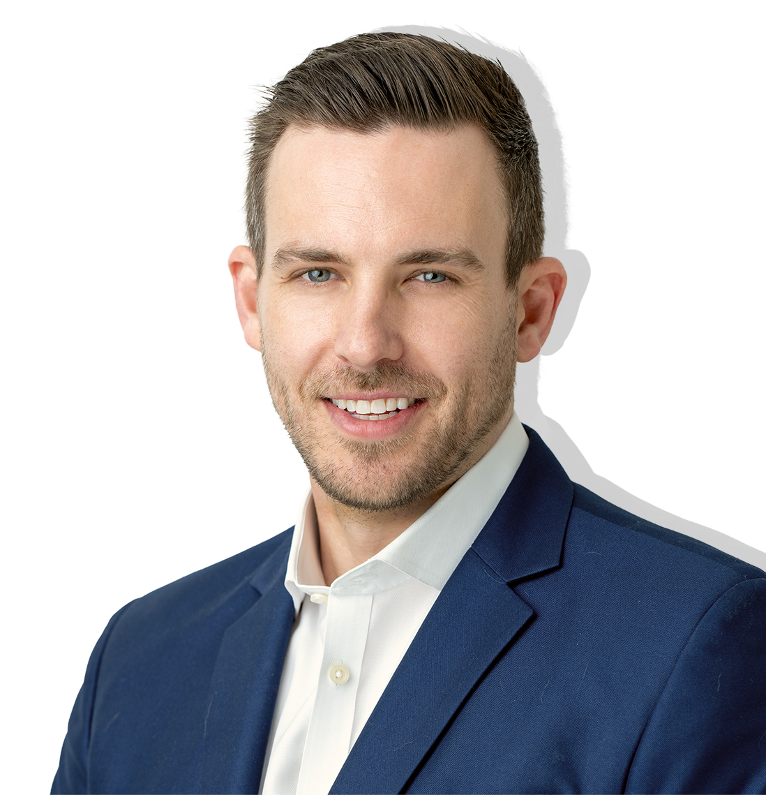 Professional man with light brown hair, blue eyes, and a beard, wearing a navy suit and white shirt, smiling.