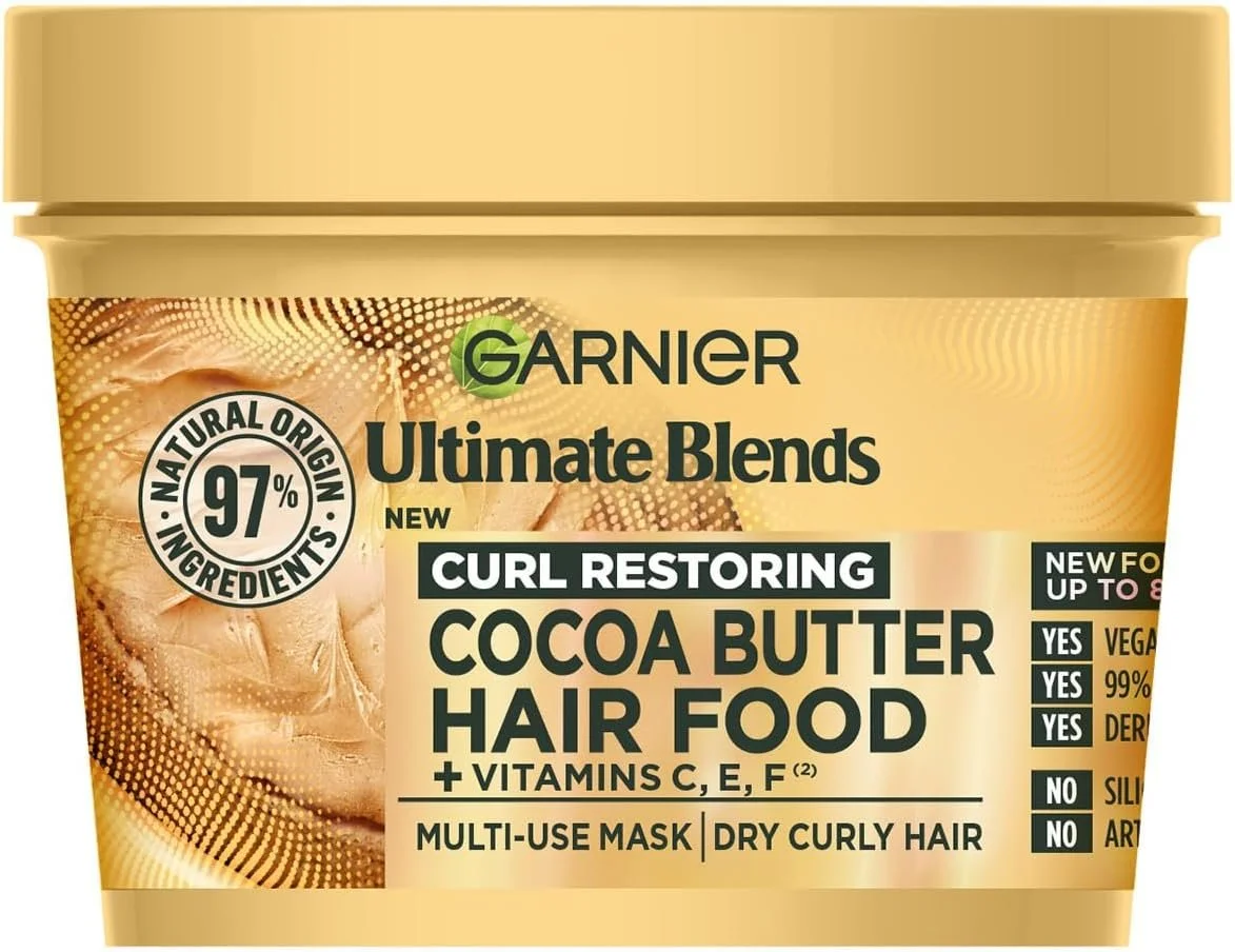 Garnier Ultimate Blends Curl Restoring Cocoa Butter Hair Food container with multi-use mask for dry curly hair, containing vitamins C, E, F. Features natural ingredients, vegan, gluten-free, 97% ingredients of natural origin.