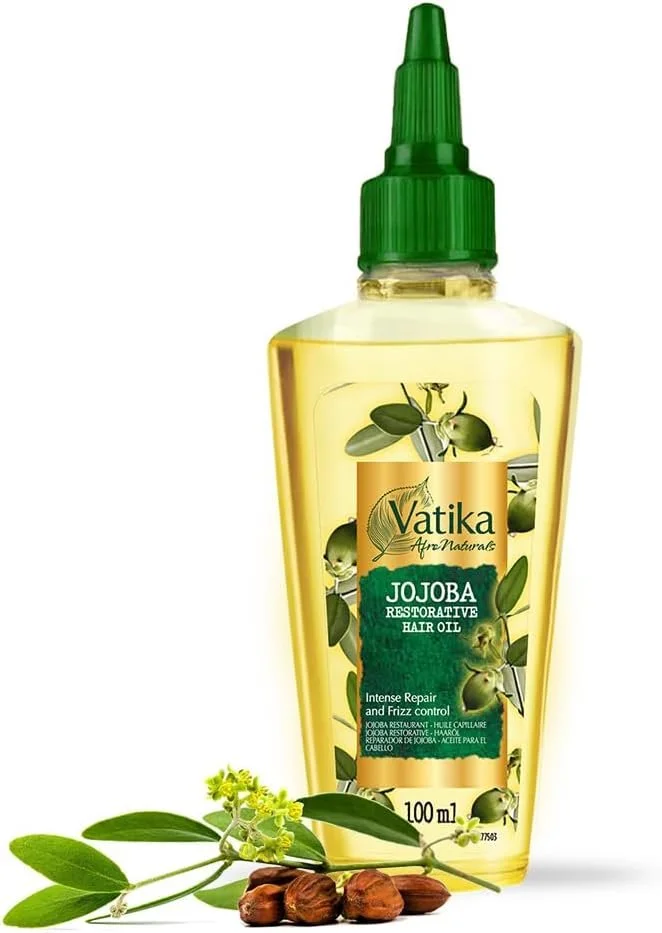 Bottle of Vatika Jojoba Restorative Hair Oil with jojoba seeds and leaves at the base.