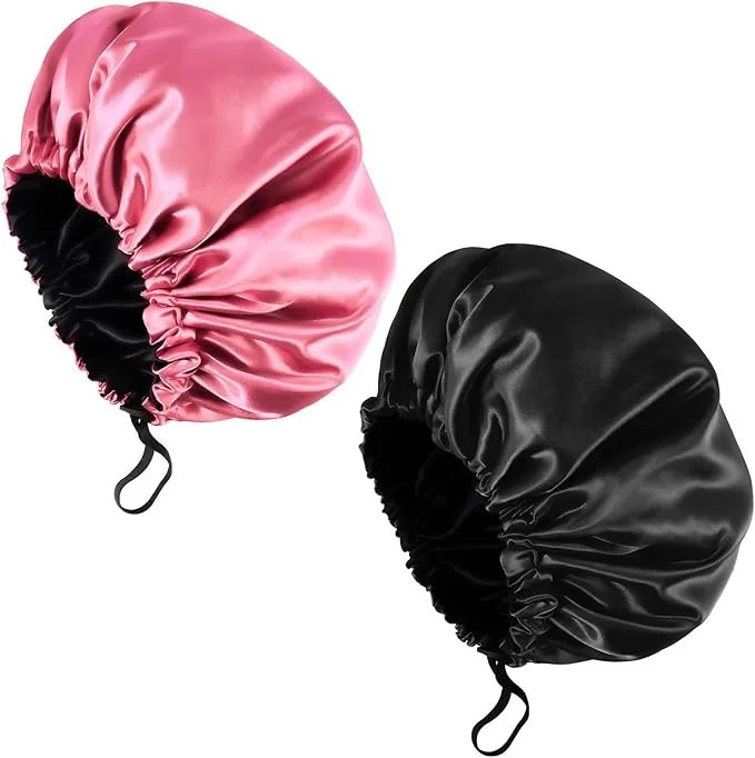 Pink and black satin bonnet caps with elastic edges and a strap.