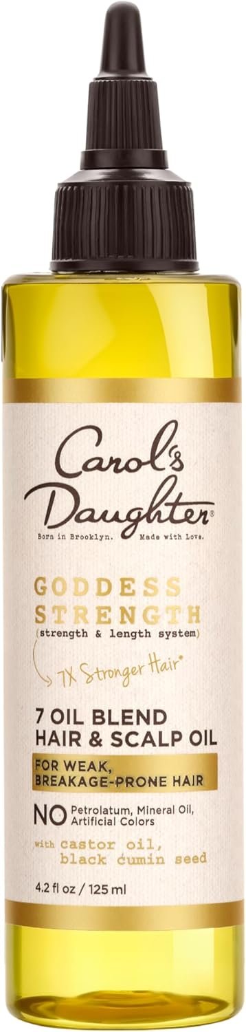 A bottle of Carol's Daughter Goddess Strength 7 Oil Blend Hair & Scalp Oil with a dropper cap, labeled for weak, breakage-prone hair, containing castor oil, black cumin seed, and other ingredients.