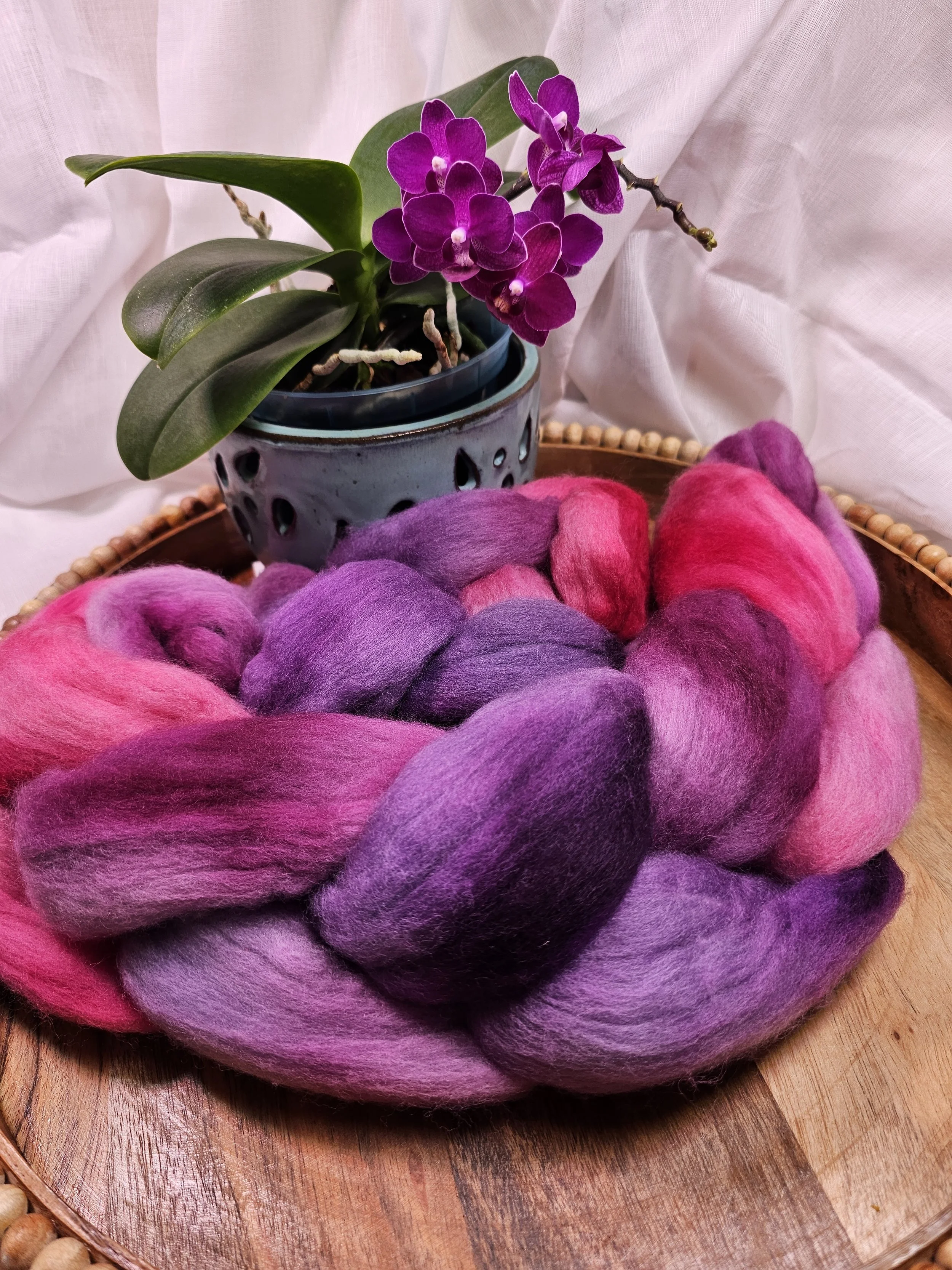 Orchid colored hand dyed wool roving.