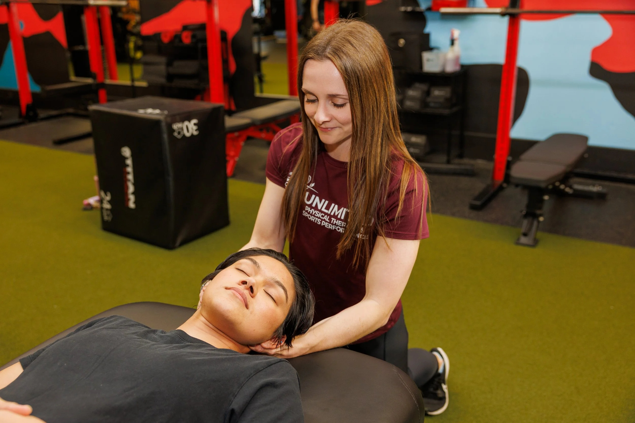 A physical therapist performing manual therapy on a client's neck.