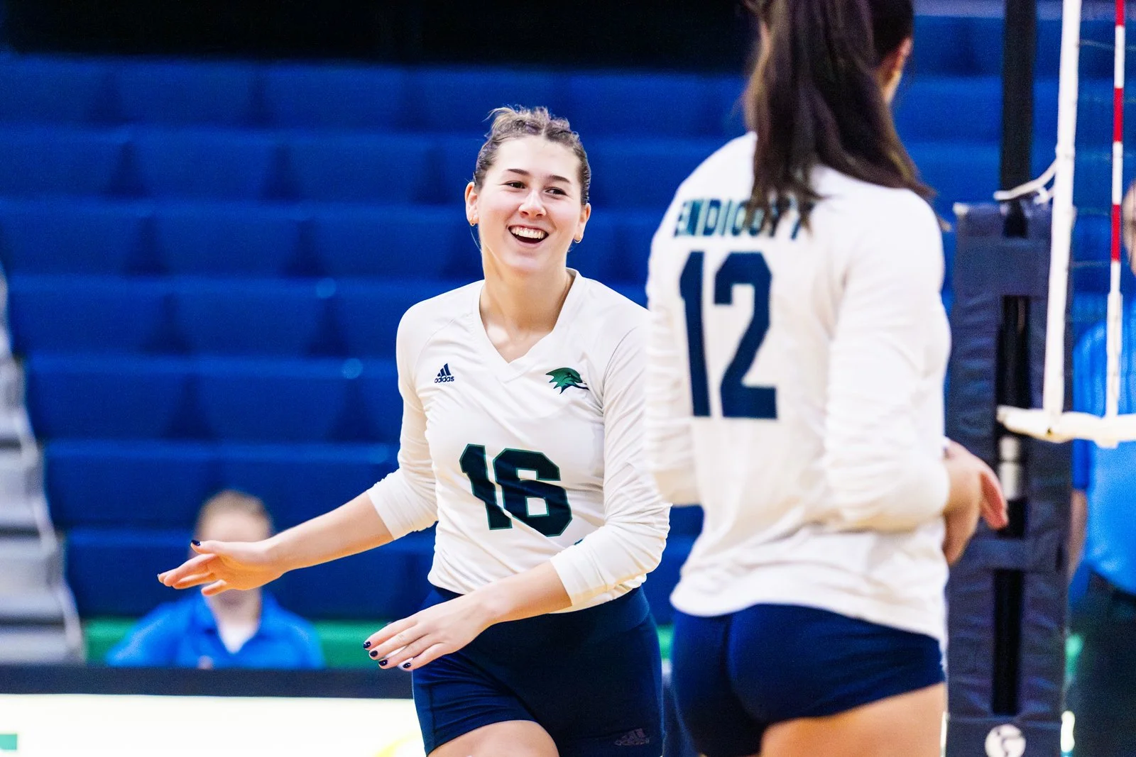 Stephanie in her volleyball uniform on the court.