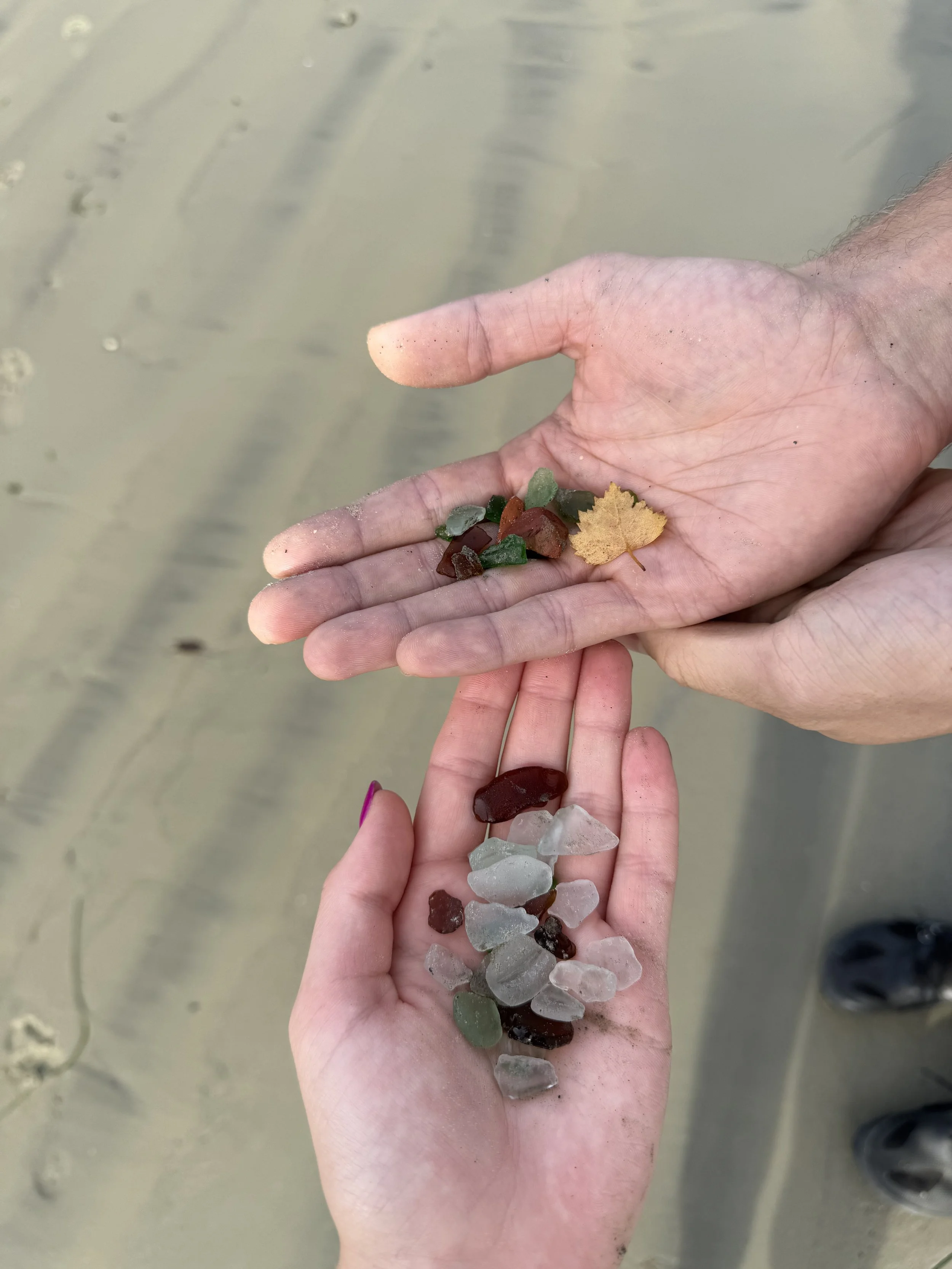 Two hands holding seaglass
