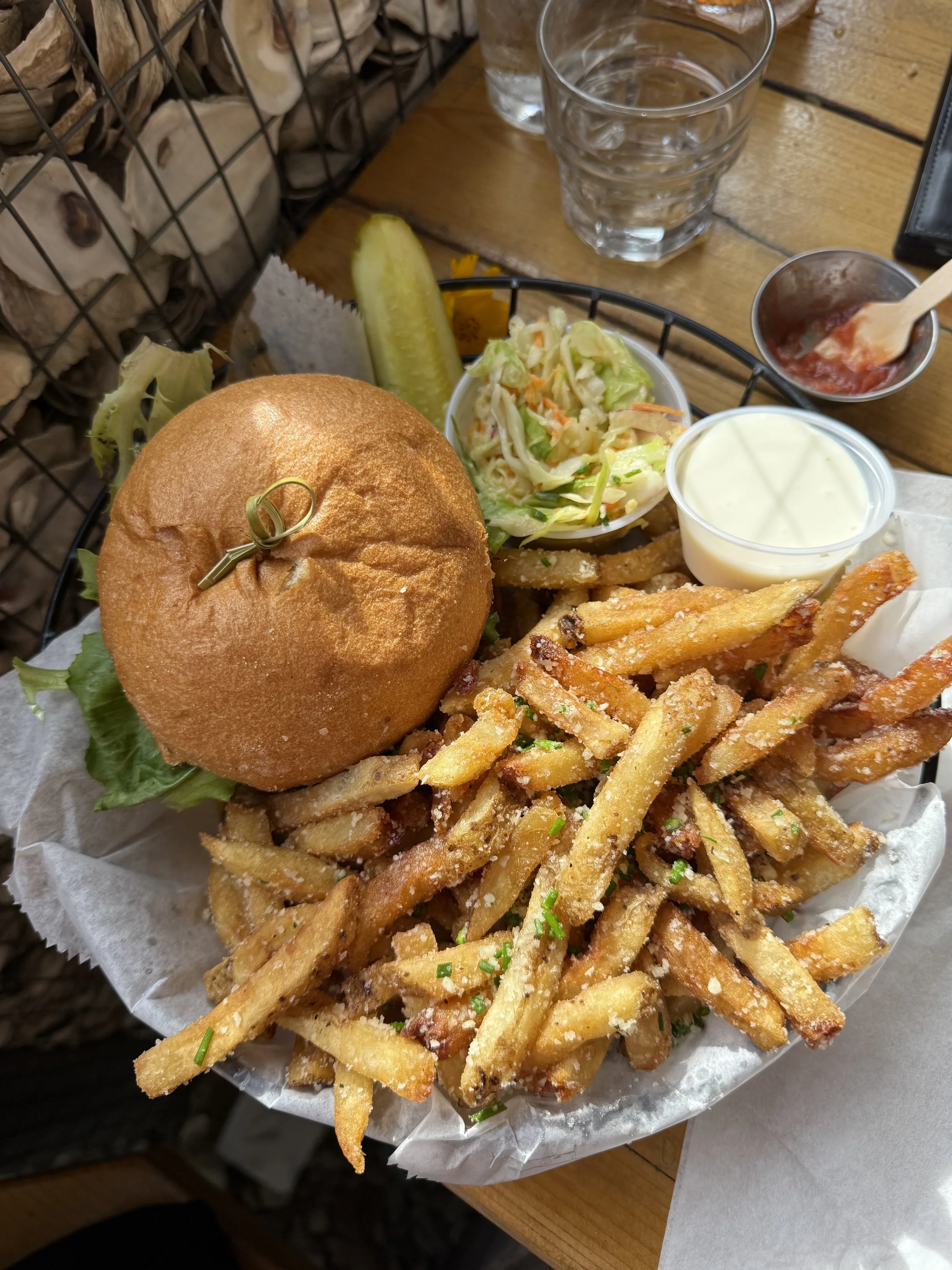 A burger and fries with coleslaw for a side