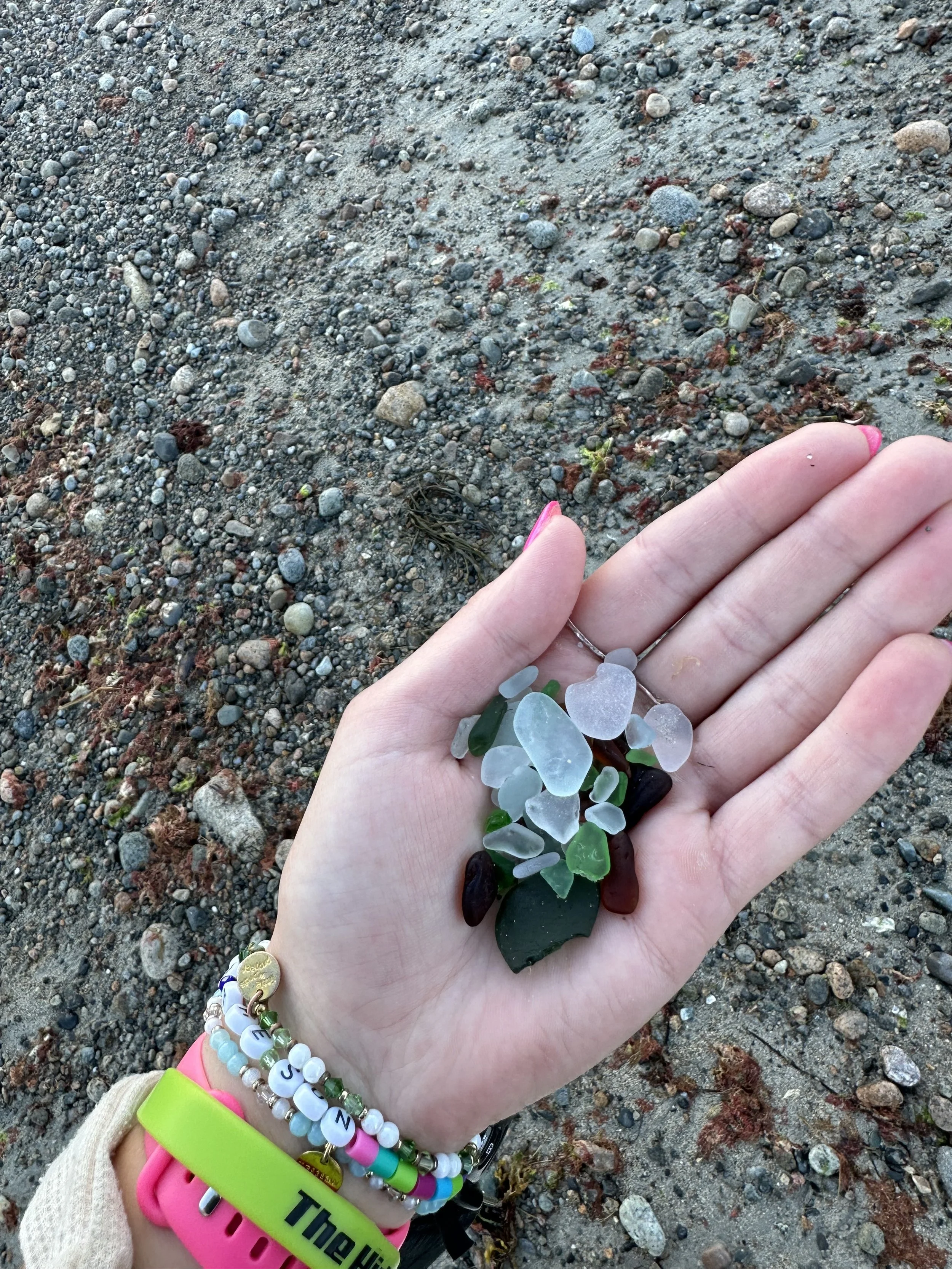 A hand holding seaglass