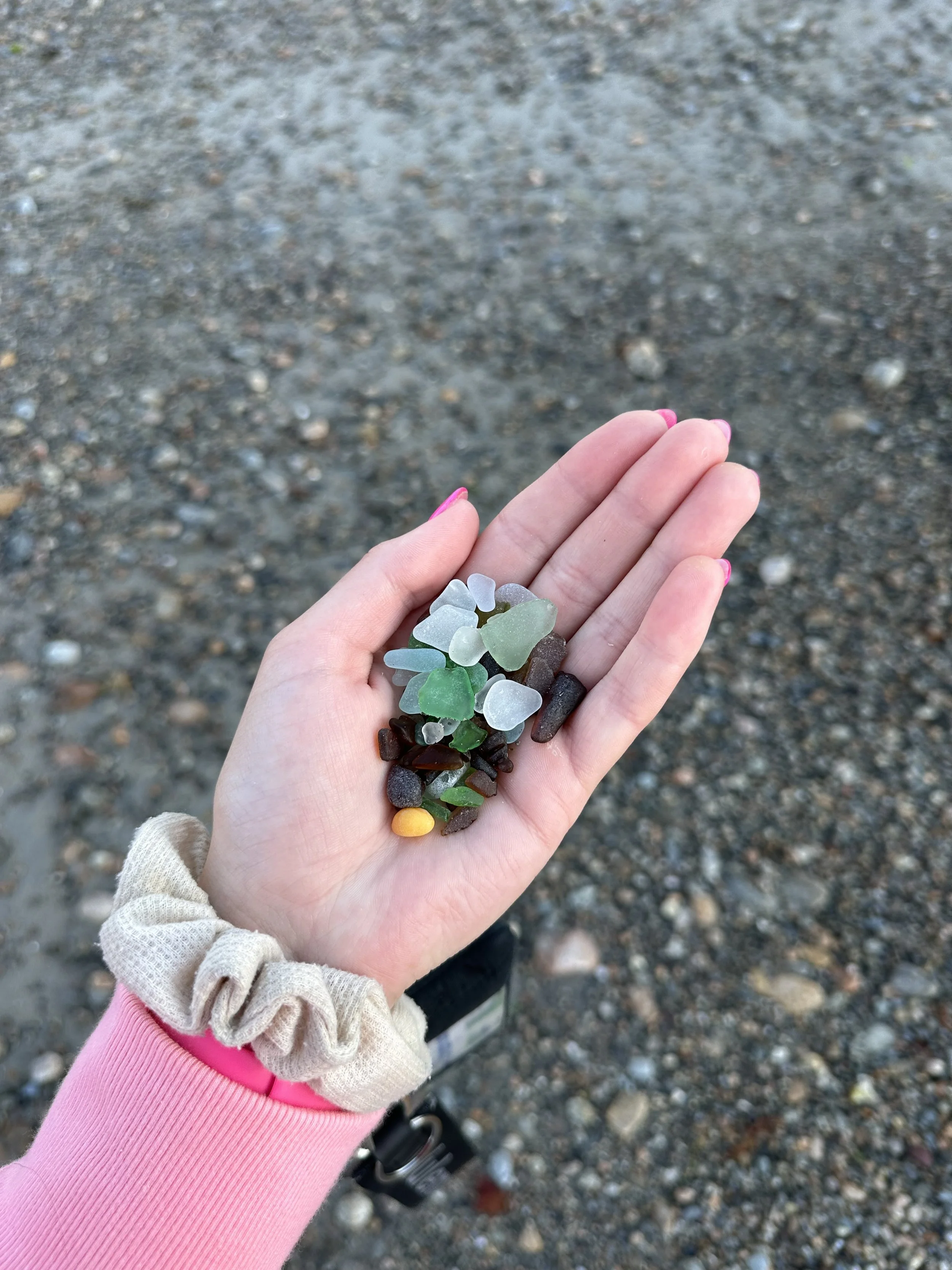 A hand holding seaglass