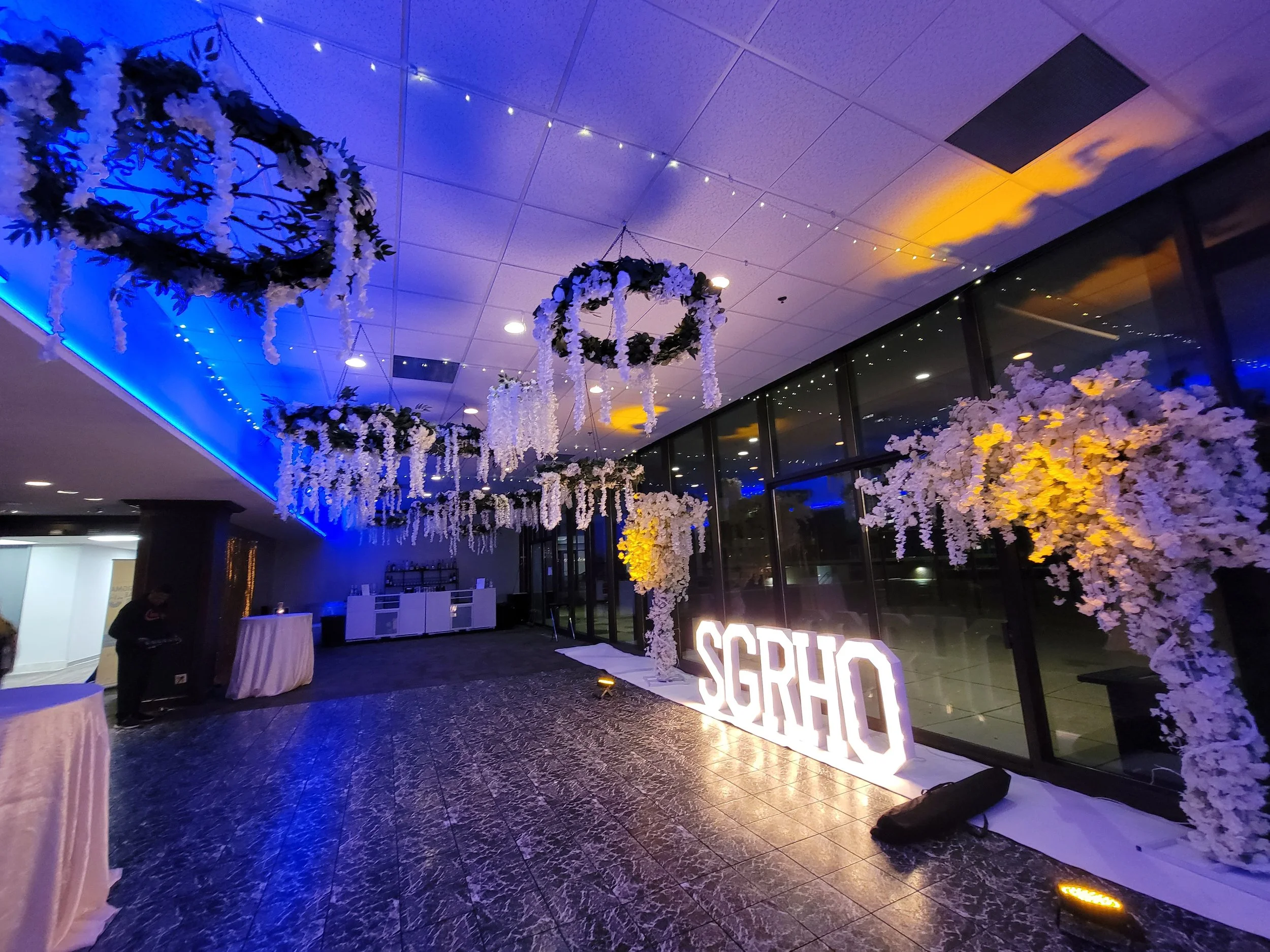 Custom corporate lighting and branded decor at JPS Events at Regions Tower. Features in-house luxury floral design, custom illuminated neon branding, and versatile indoor ballroom space in downtown Indianapolis.