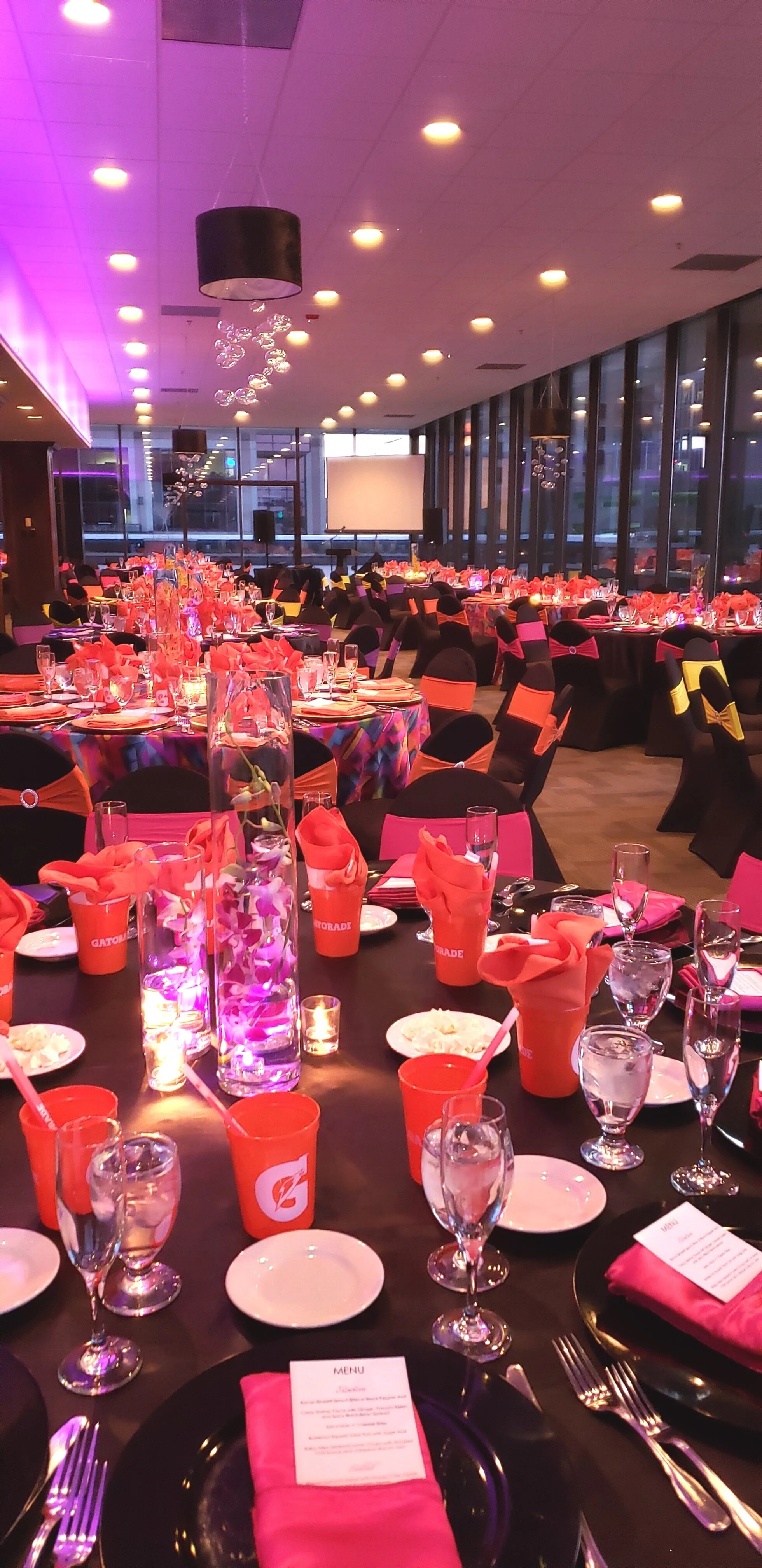 Custom branded corporate party for Pepsi-Gatorade,  tablescape with Gatorade theme at JPS Events at Regions Tower, highlighting the venue's flexible blank-canvas layout, in-house setup.