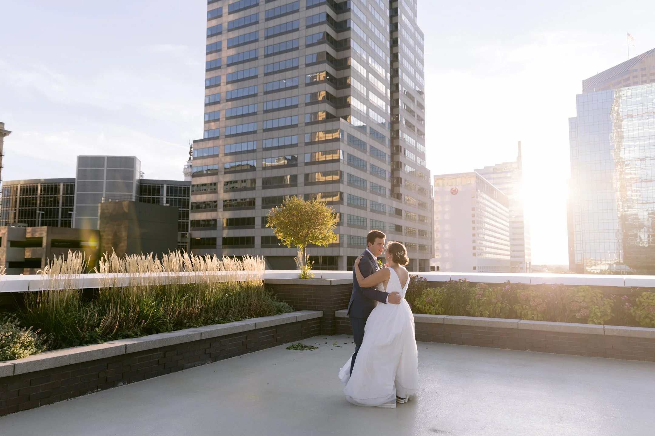 Sunset couple dance on the 11,000 sq ft penthouse terrace at JPS Events at Regions Tower. Offers 360 downtown Indy skyline views, proximity to 6 walkable hotels, and hands-on owner day-of coordination.