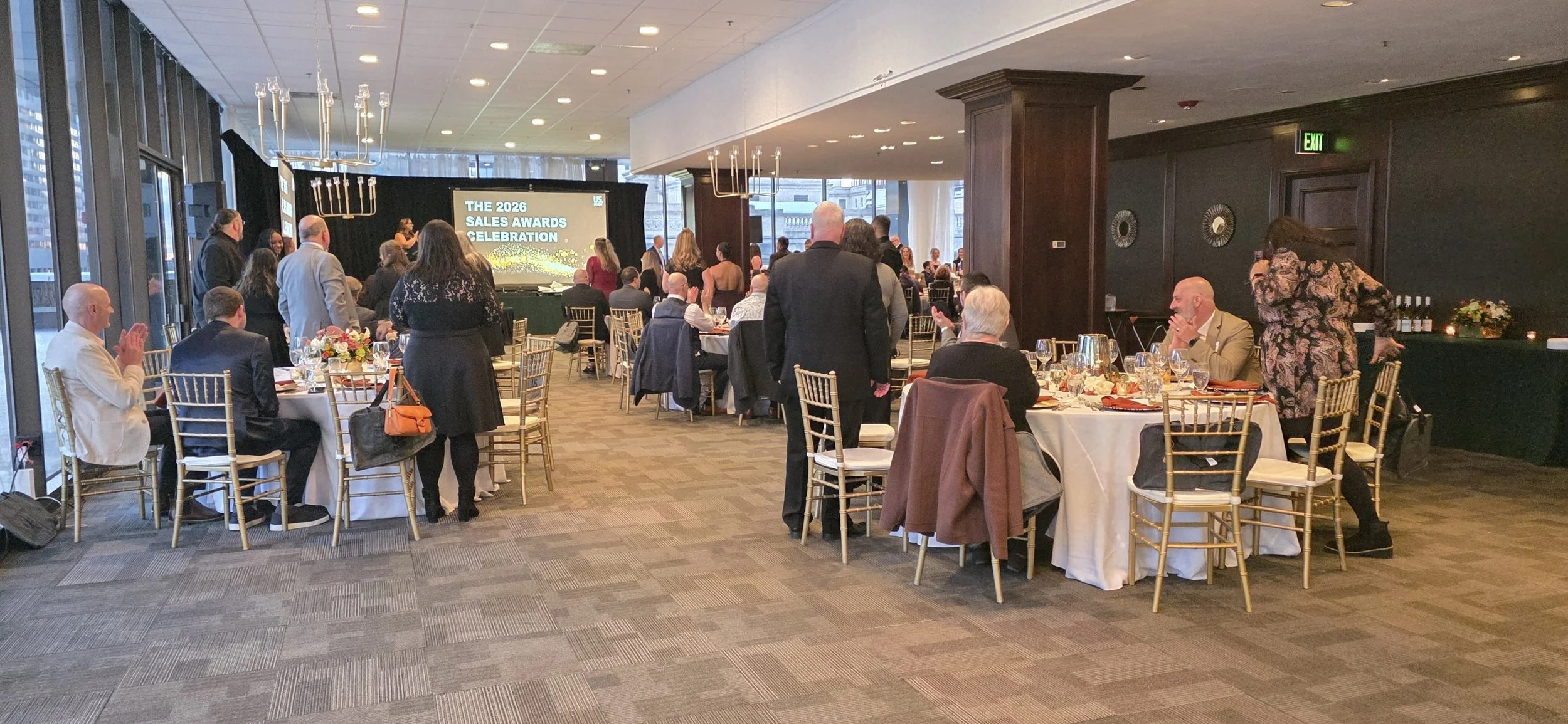 Corporate Sales Awards Celebration at JPS Events at Regions Tower, featuring integrated AV stage production, gold chairs, and expert in-house event coordination in downtown Indianapolis.