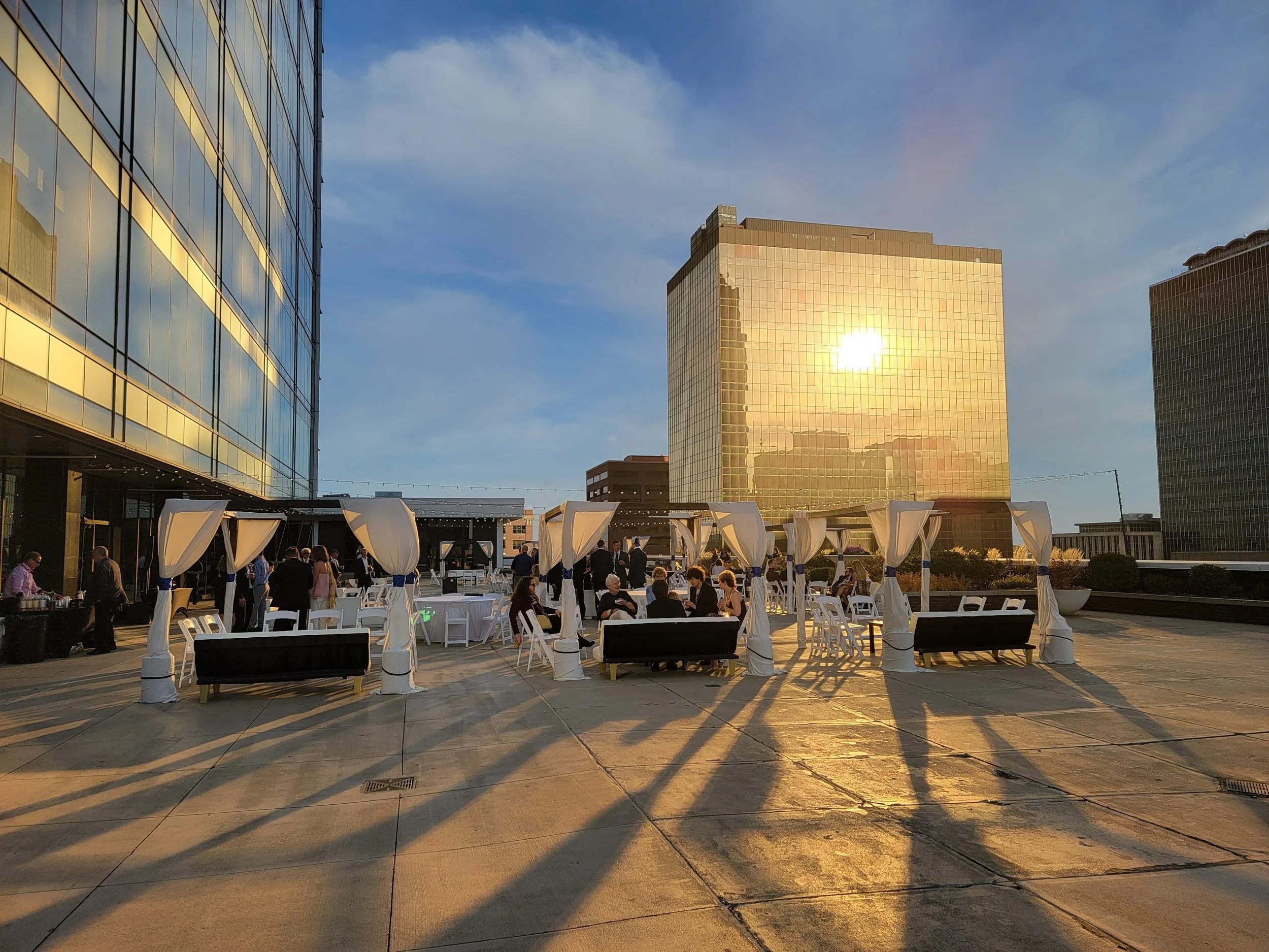 Tailored outdoor corporate reception layout with draped canopy tents on the 5th-floor penthouse terrace at JPS Events at Regions Tower, featuring complete in-house setup and teardown with zero late-out fees.
