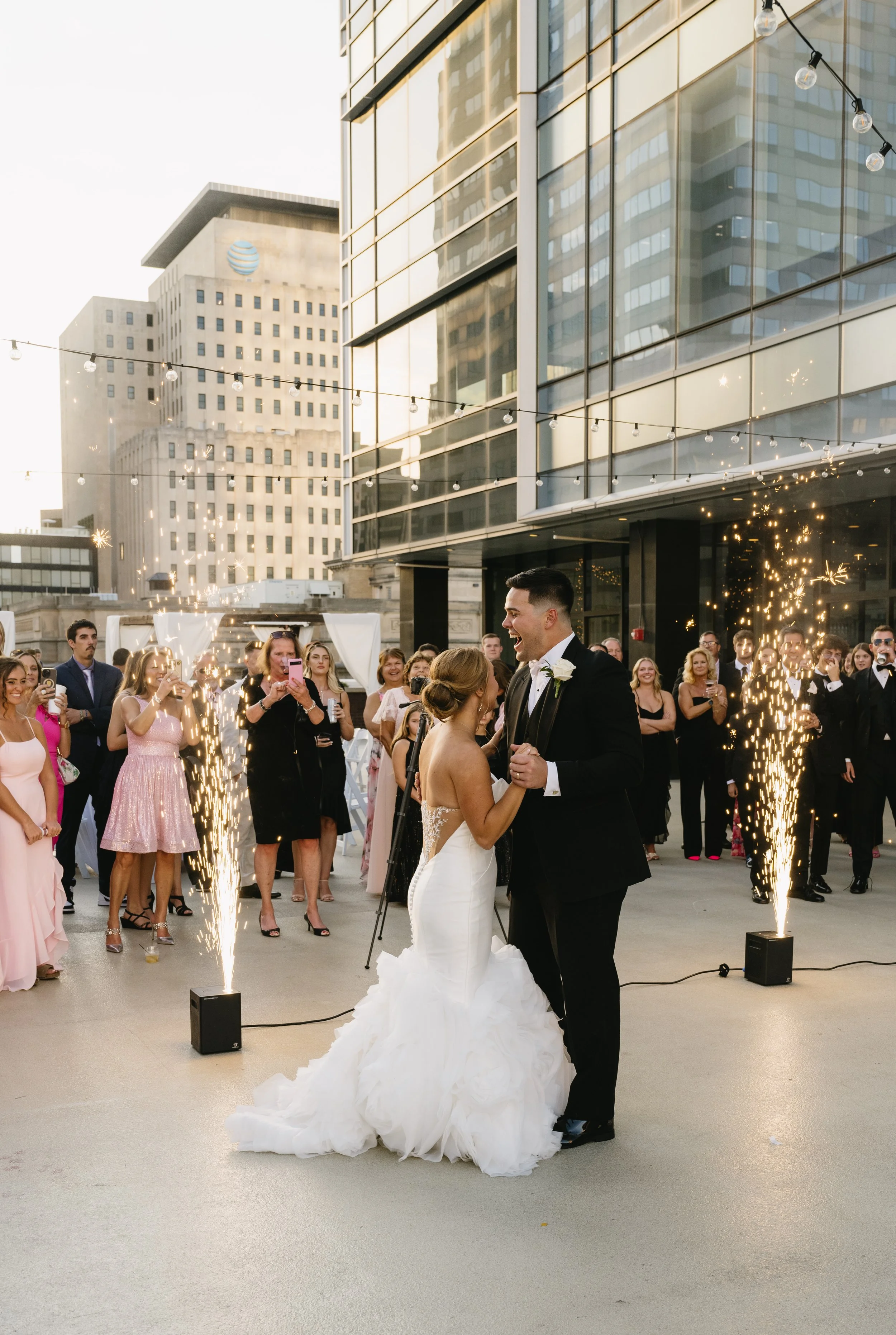 Newlyweds dancing surrounded by indoor cold sparklers at JPS Events at Regions Tower, showcasing our indoor ballroom dance floor, built-in lighting effects, and weather-proof luxury wedding design in downtown Indianapolis.