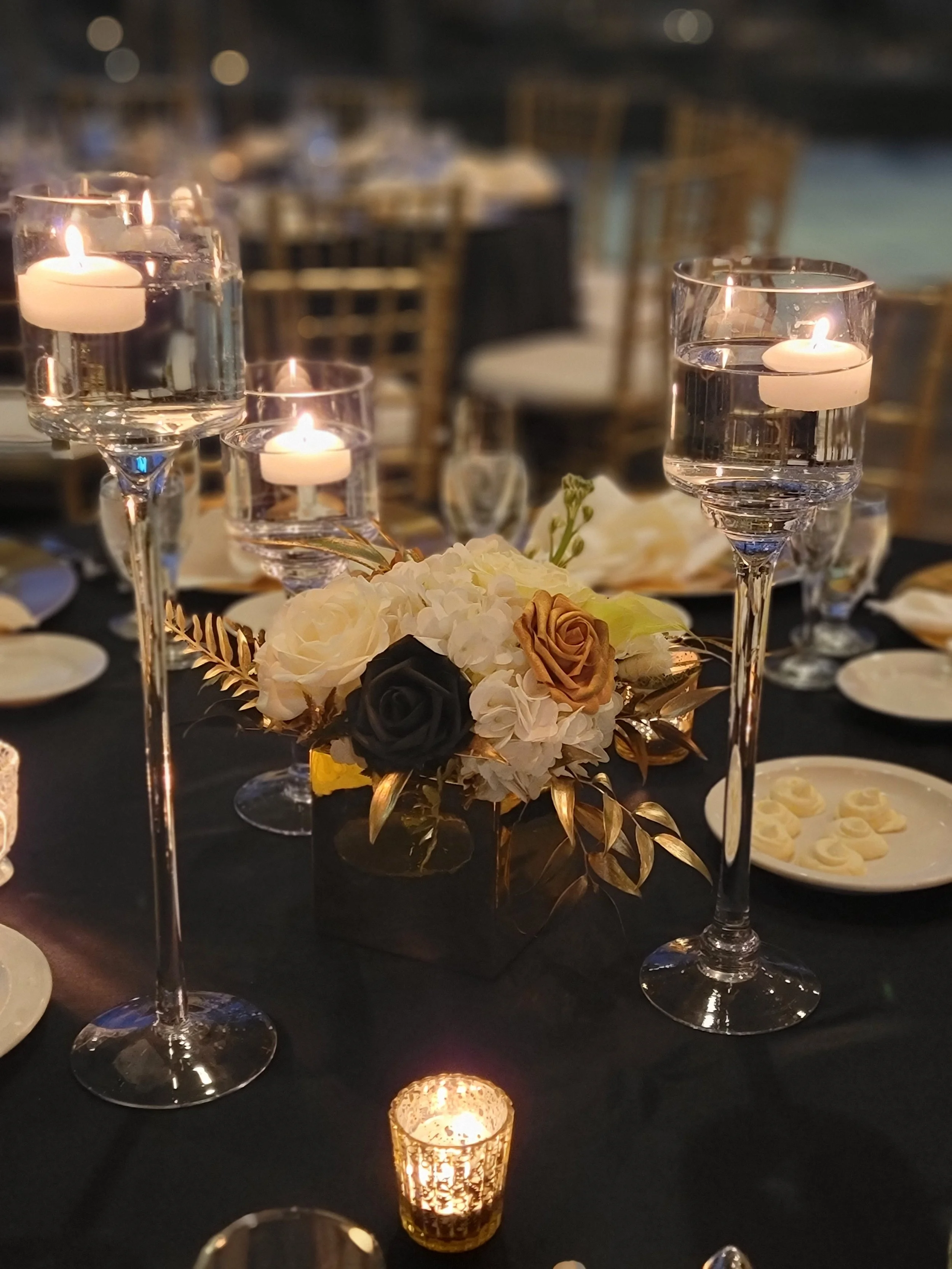 Elegant corporate dinner tablescape designed by JPS Events at Regions Tower, featuring custom in-house floral arrangements, warm candlelit ambiance, and all-inclusive event planning services in downtown Indianapolis.