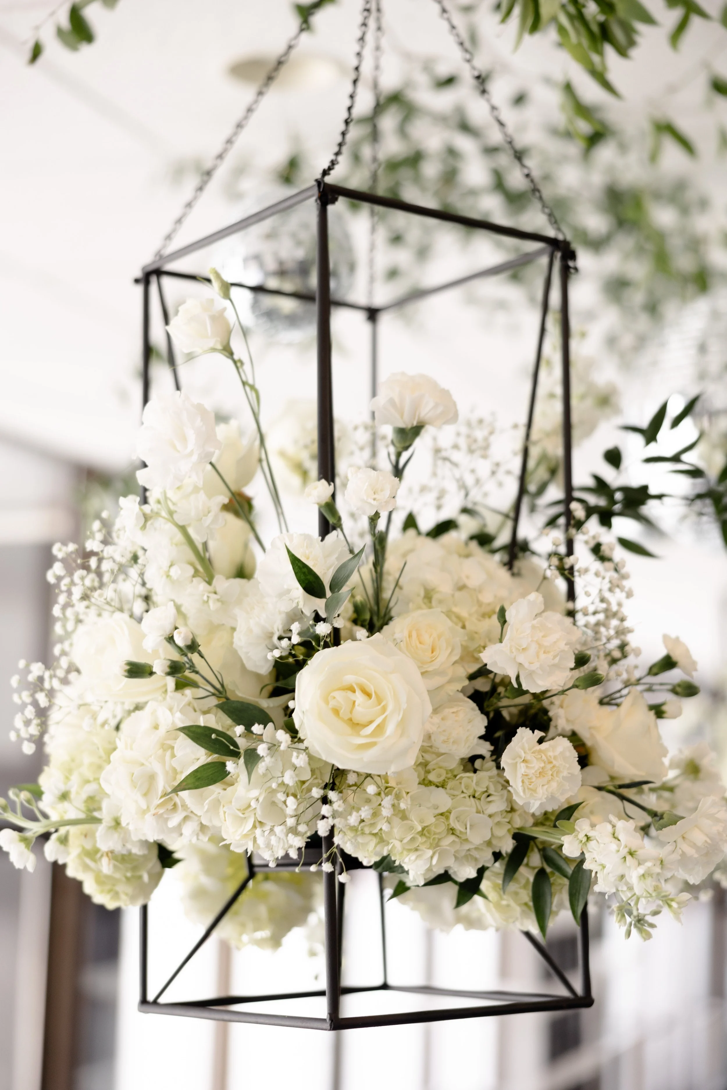 Modern geometric hanging floral installation by the in-house floral team at JPS Events at Regions Tower. Illustrates our custom wedding design process and high-end metropolitan chic decor in downtown Indianapolis.