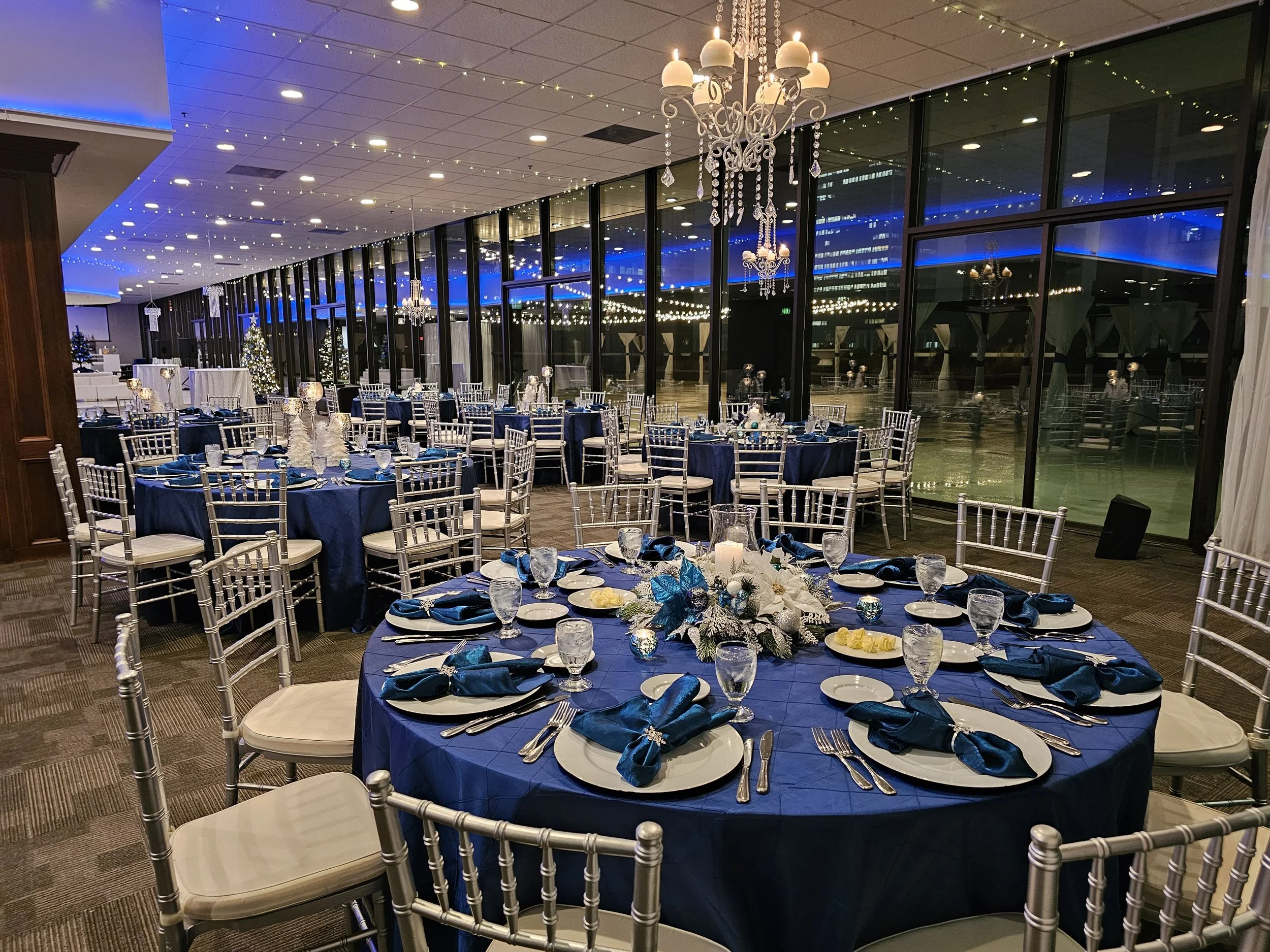 Corporate holiday gala inside the indoor ballroom at JPS Events at Regions Tower, featuring in-house seasonal decor, crystal chandeliers, floor-to-ceiling windows, and complete event coordination in downtown Indy.
