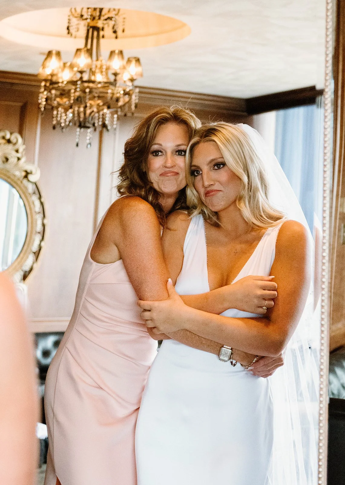 Bride relaxing during morning-of prep in the private executive suite at JPS Events at Regions Tower in downtown Indy. Features luxury dark wood paneling, crystal chandeliers, private prep suites, & stress-free family coordination.