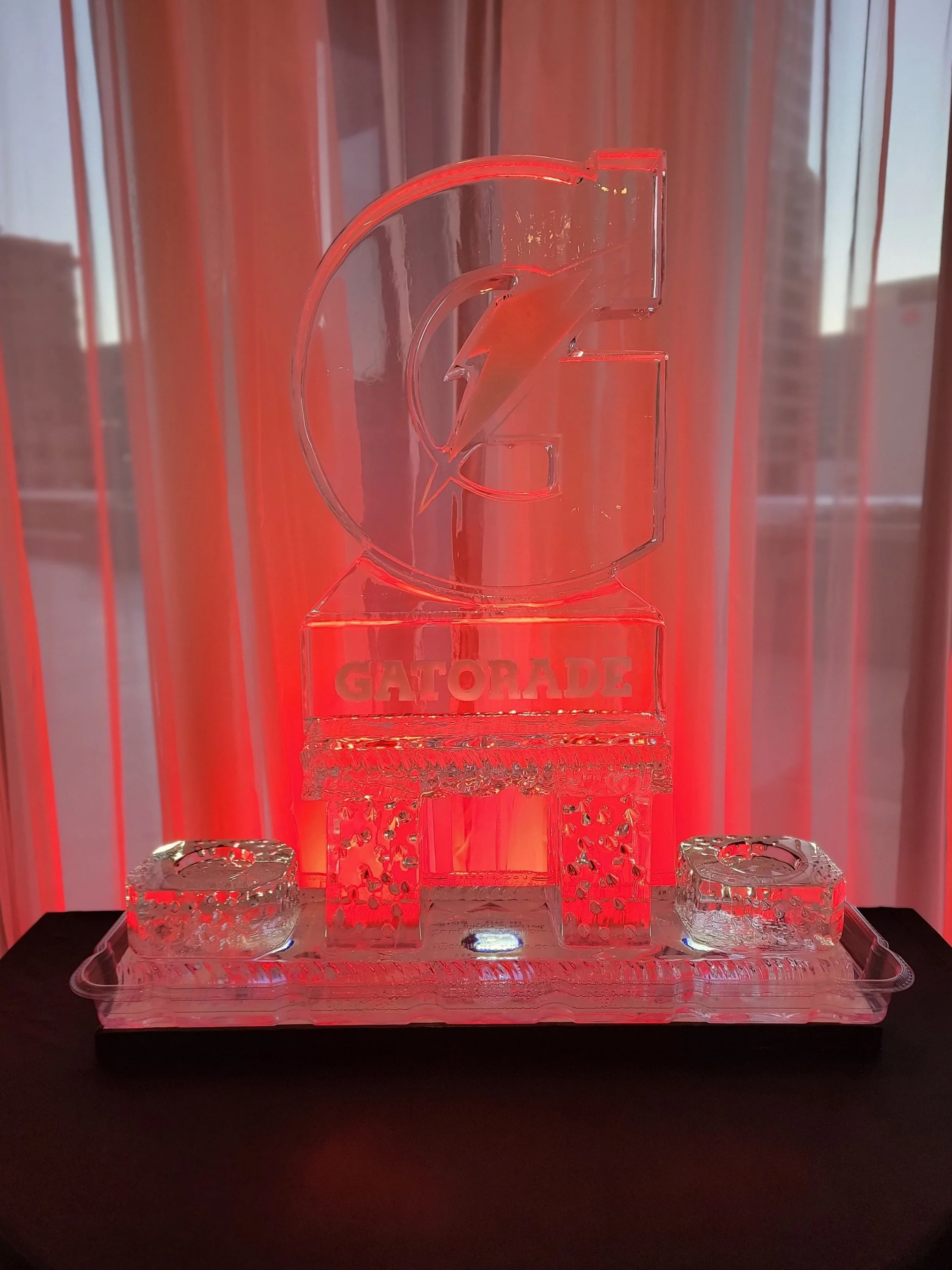 Custom illuminated Gatorade ice sculpture at JPS Events at Regions Tower, showcasing specialized corporate event branding, dynamic LED lighting, and full-service event production in downtown Indianapolis.