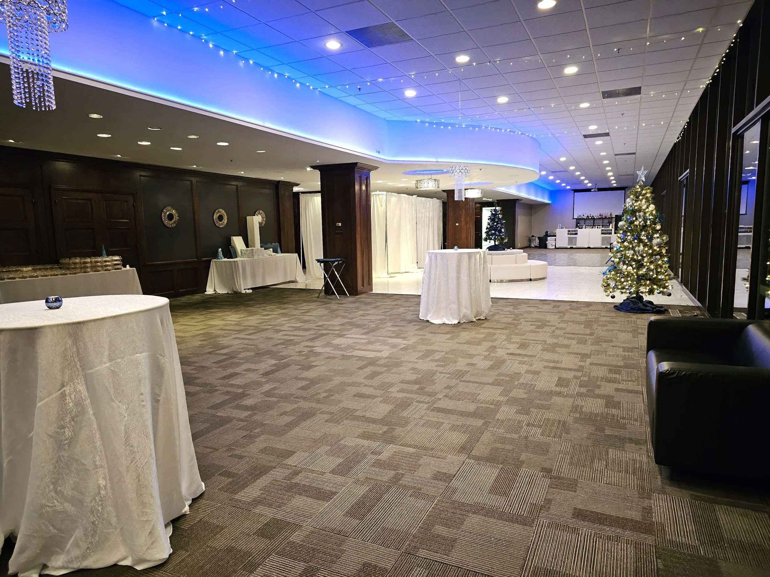 Corporate holiday event at JPS Events at Regions Tower, featuring polished white marble floors, festive architectural lighting, versatile seating layouts, and convenient access near major downtown hotels.