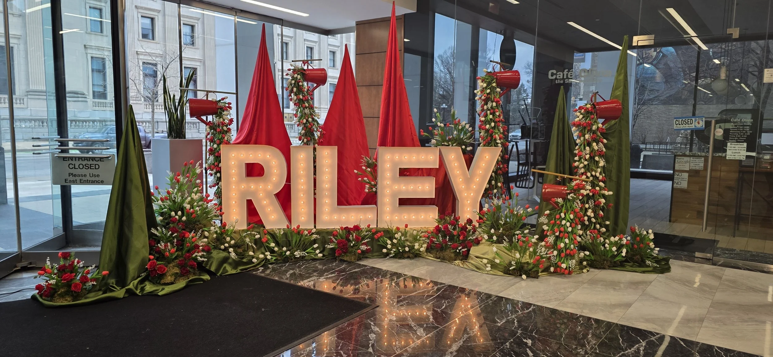 Custom illuminated marquee branding framed by custom red floral design at the Riley Children’s Hospital RED Gala, highlighting JPS Events at Regions Tower's in-house floral team, bespoke decor styling, and full-service event production in downtown In