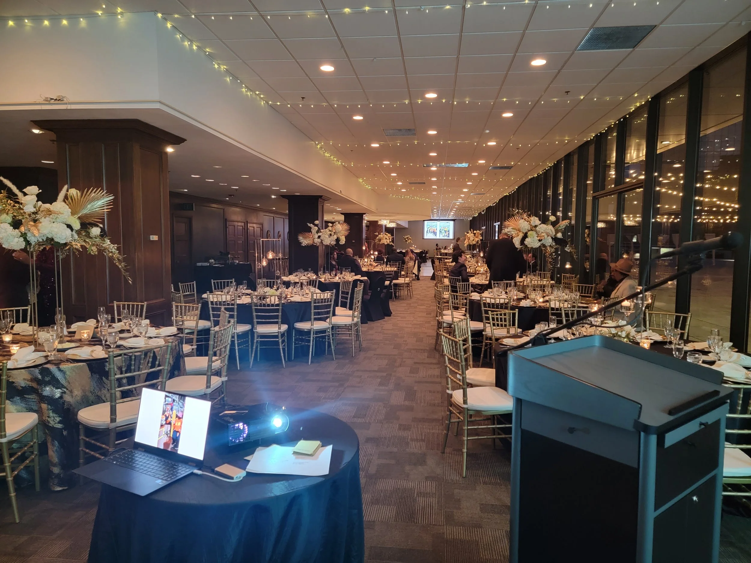 Evening corporate gala in the indoor ballroom at JPS Events at Regions Tower, featuring polished white marble floors, in-house floral decor, dynamic lighting, and convenient access to six downtown Indy hotels.