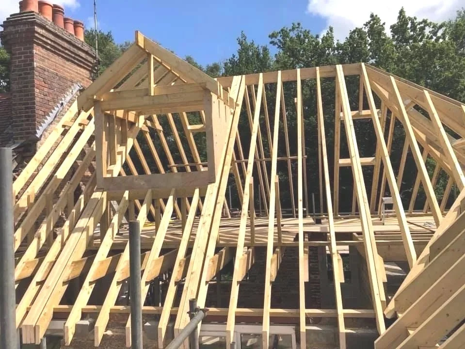 Wooden roof trusses and framing for a house under construction.