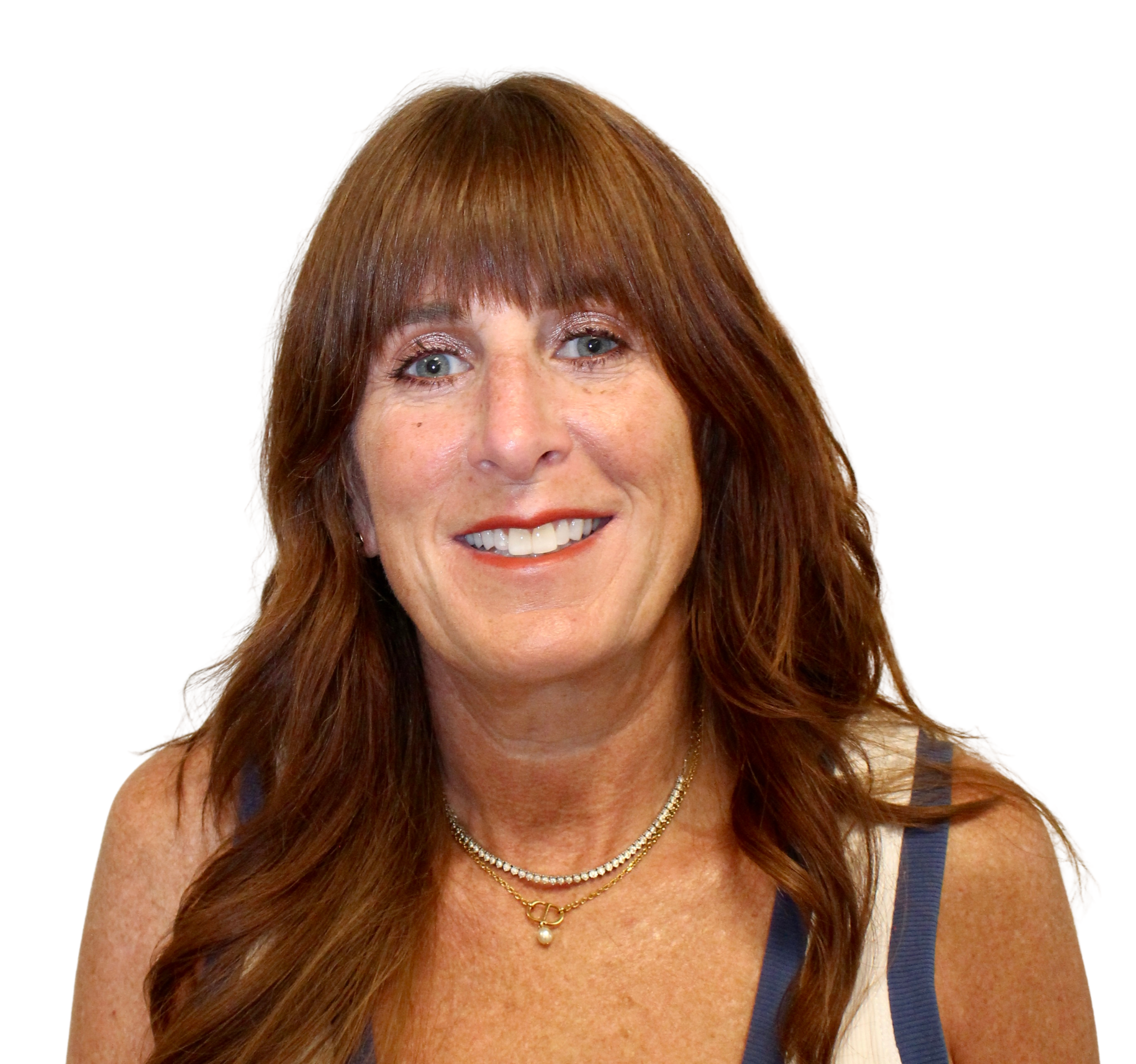 A woman with red hair smiling, wearing layered necklaces and a dress with blue accents, against a white background.