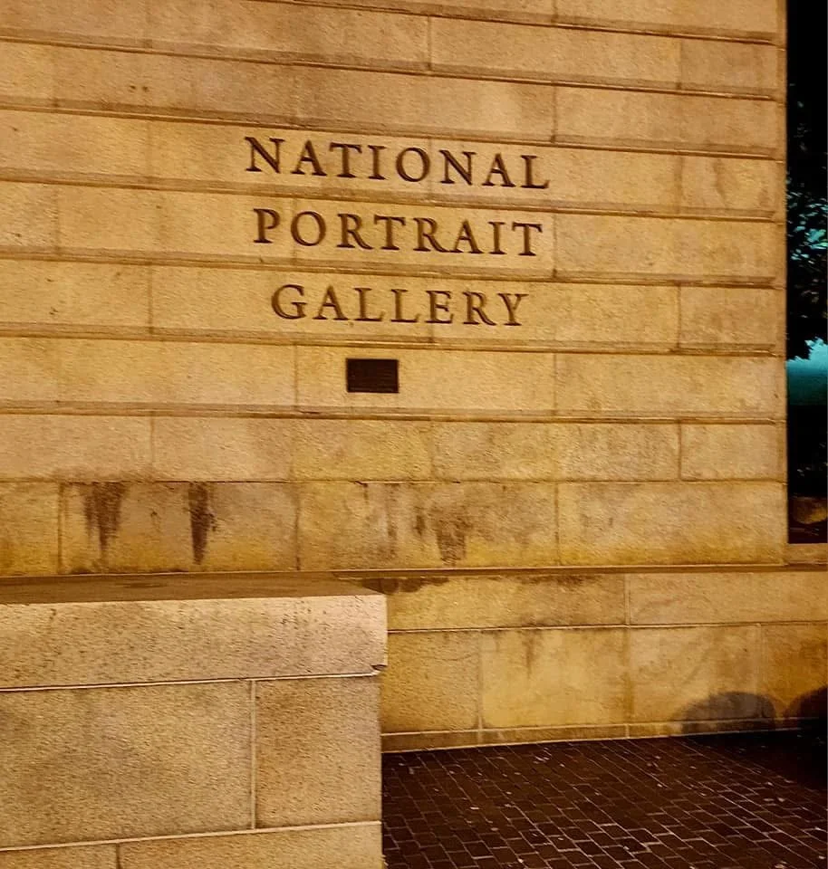 A stone wall with the engraved sign 'National Portrait Gallery'.