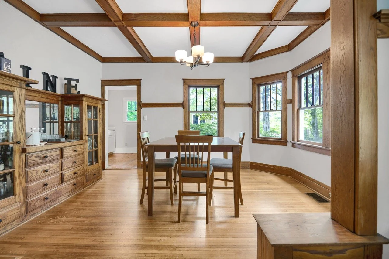 Dining room with hardwood floors and coffered ceiling captured using professional real estate photography in Fayetteville NC to highlight space, character, and increase buyer engagement