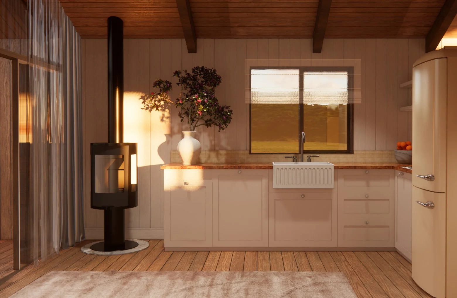 A cozy kitchen with wooden floors and ceiling beams, a window overlooking a grassy landscape, white cabinets, a farmhouse sink, a vase with pink flowers, a bowl of oranges, a retro-style refrigerator, and a black wood stove.