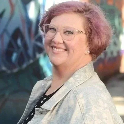 Picture of Mandy Parida in front of graffiti wall
