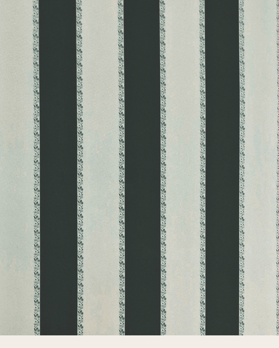 Close-up of a vintage striped wallpaper featuring alternating dark, solid lines and lighter lines with decorative floral patterns.