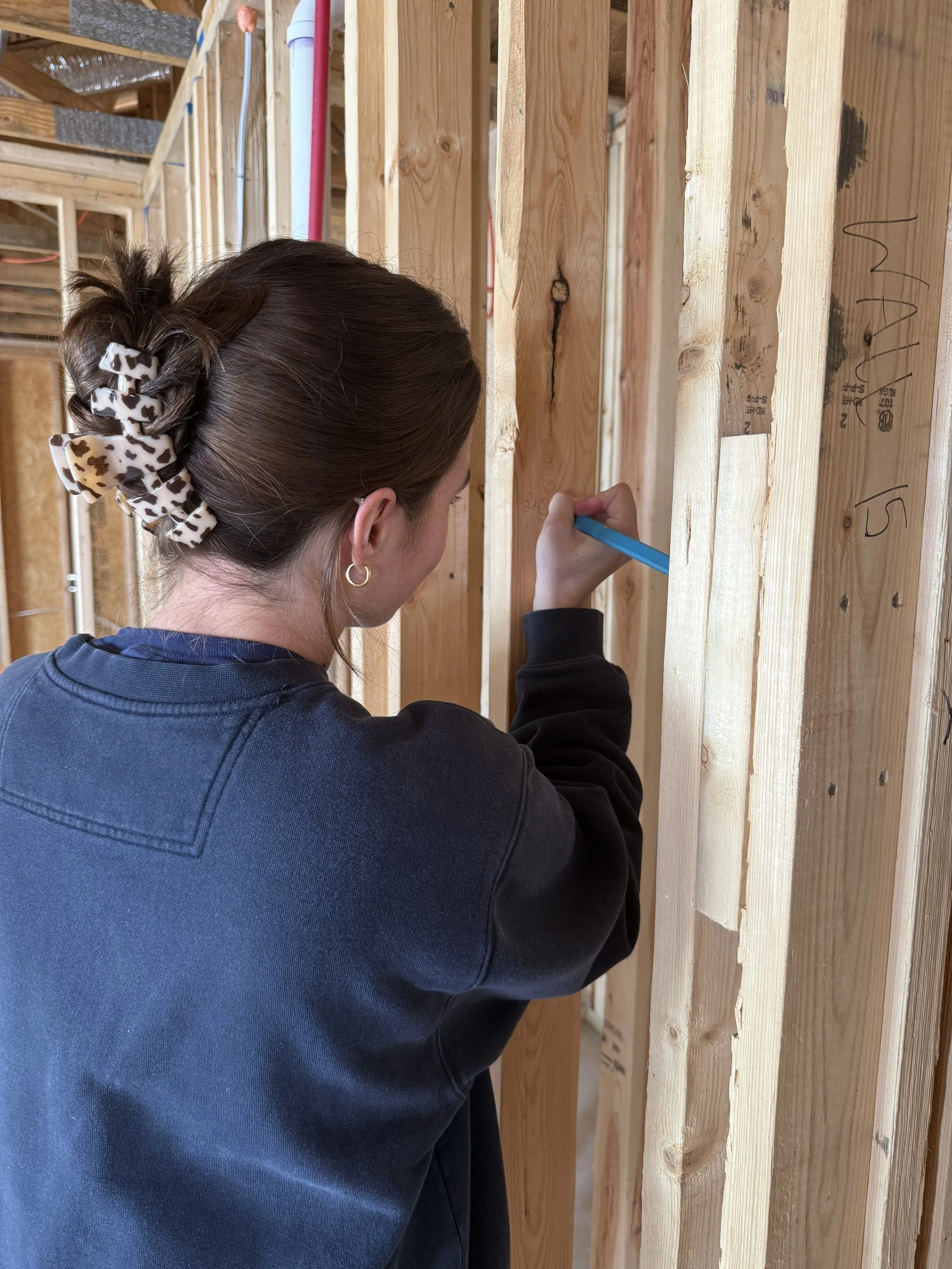 Lauren, founder of The Fold, wellness home design consultant in a construction site.