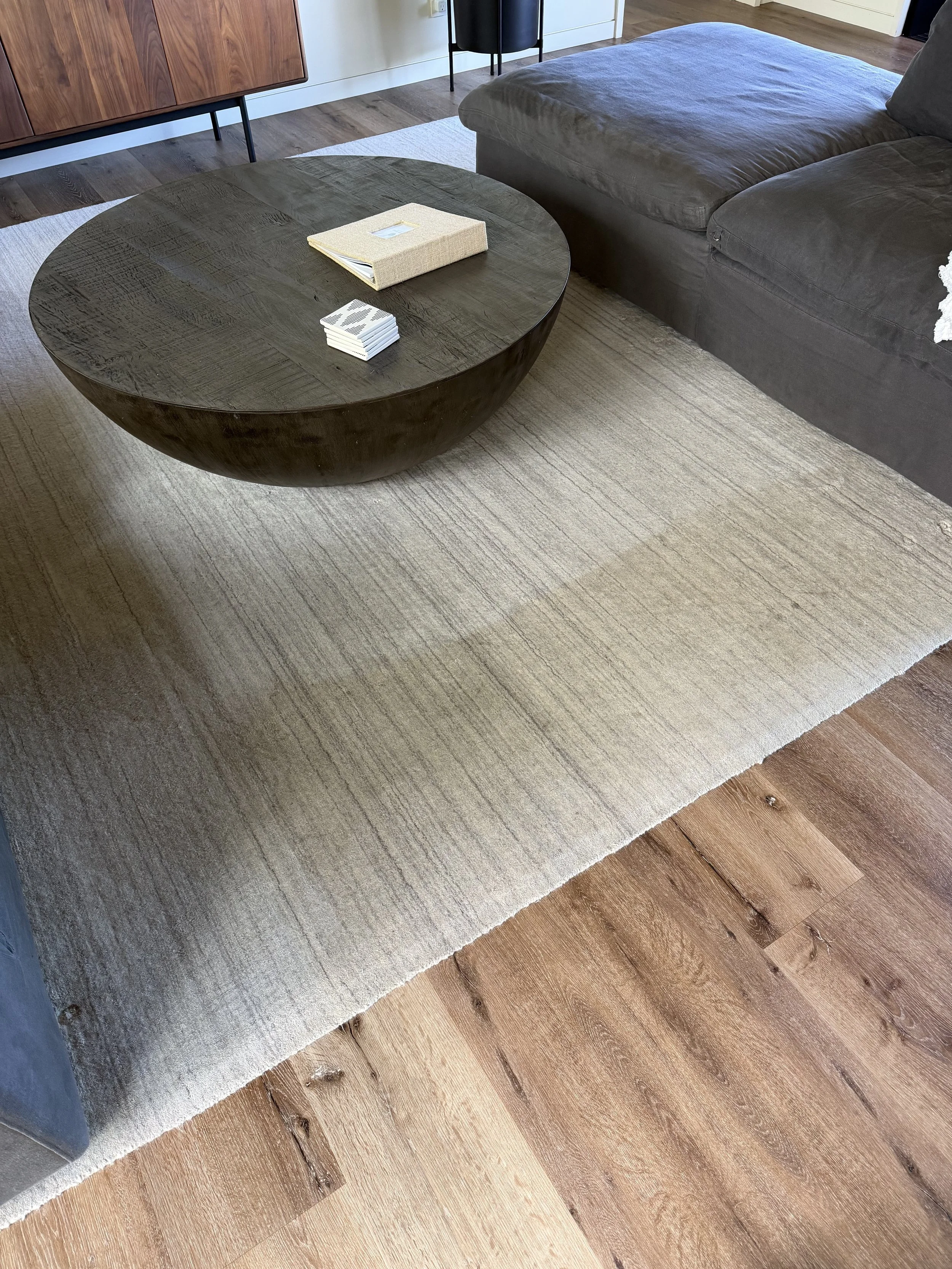 Living room in Kukui'ula home with area rug that was professionally cleaned. Stains and dirt removed. Showing before and after.