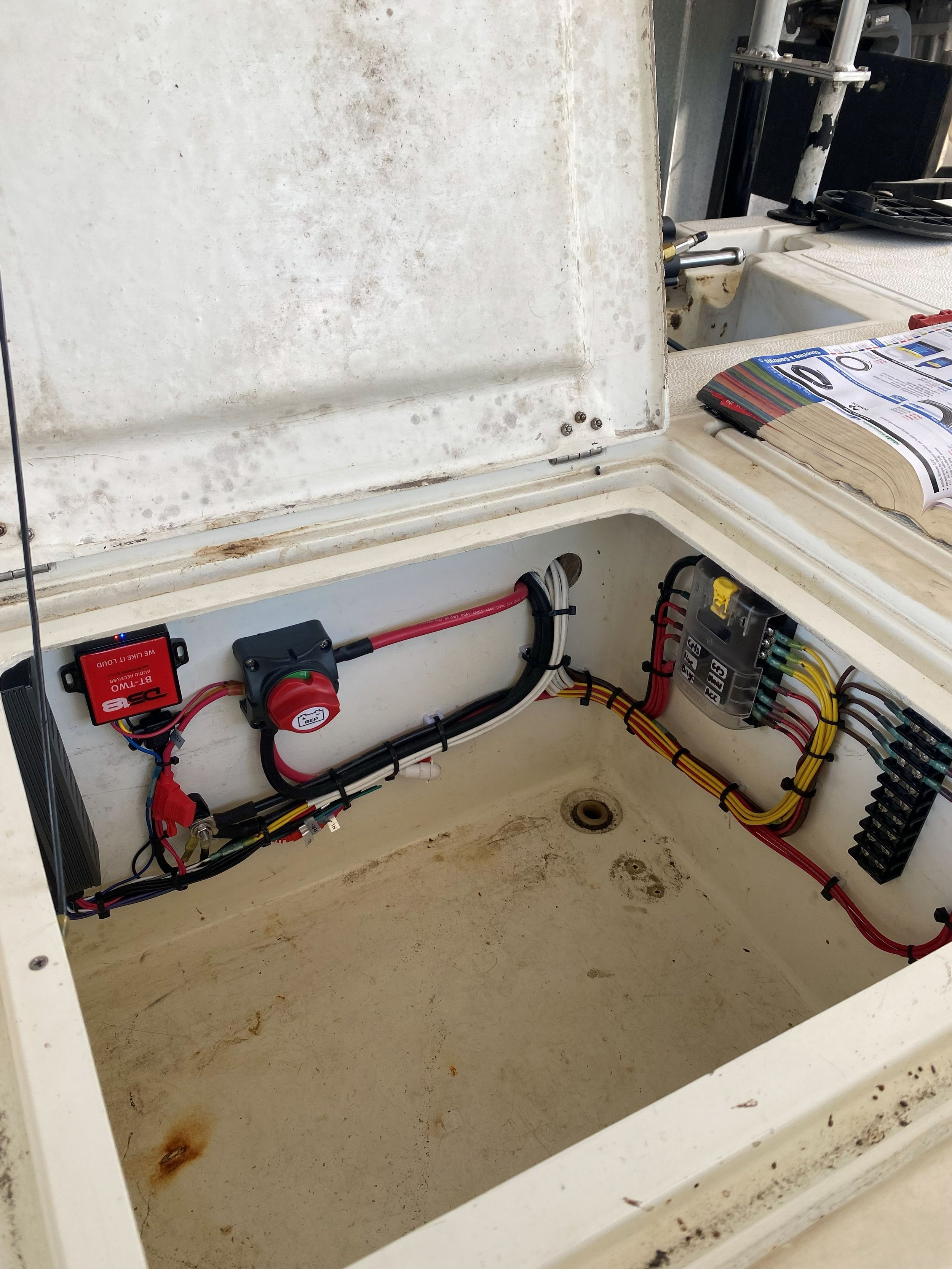Open electrical control box with wiring, circuit modules, and components inside a dirty, stained enclosure.