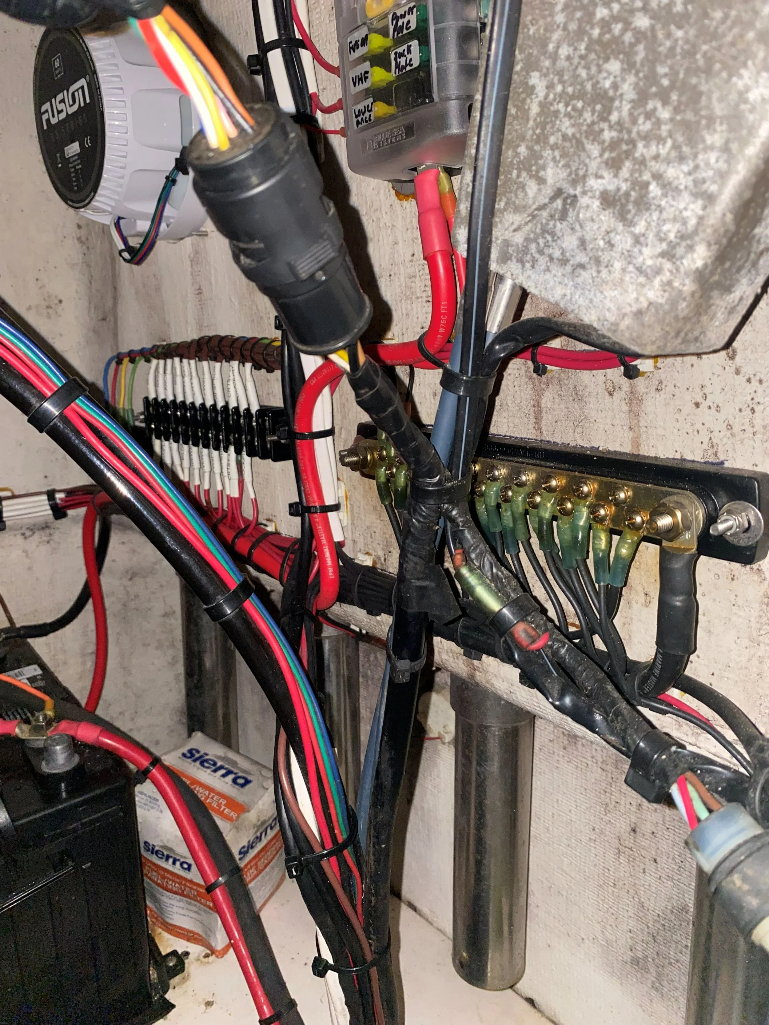 Electrical components and wiring inside an electrical panel or control box, including wires, connectors, and a filter.