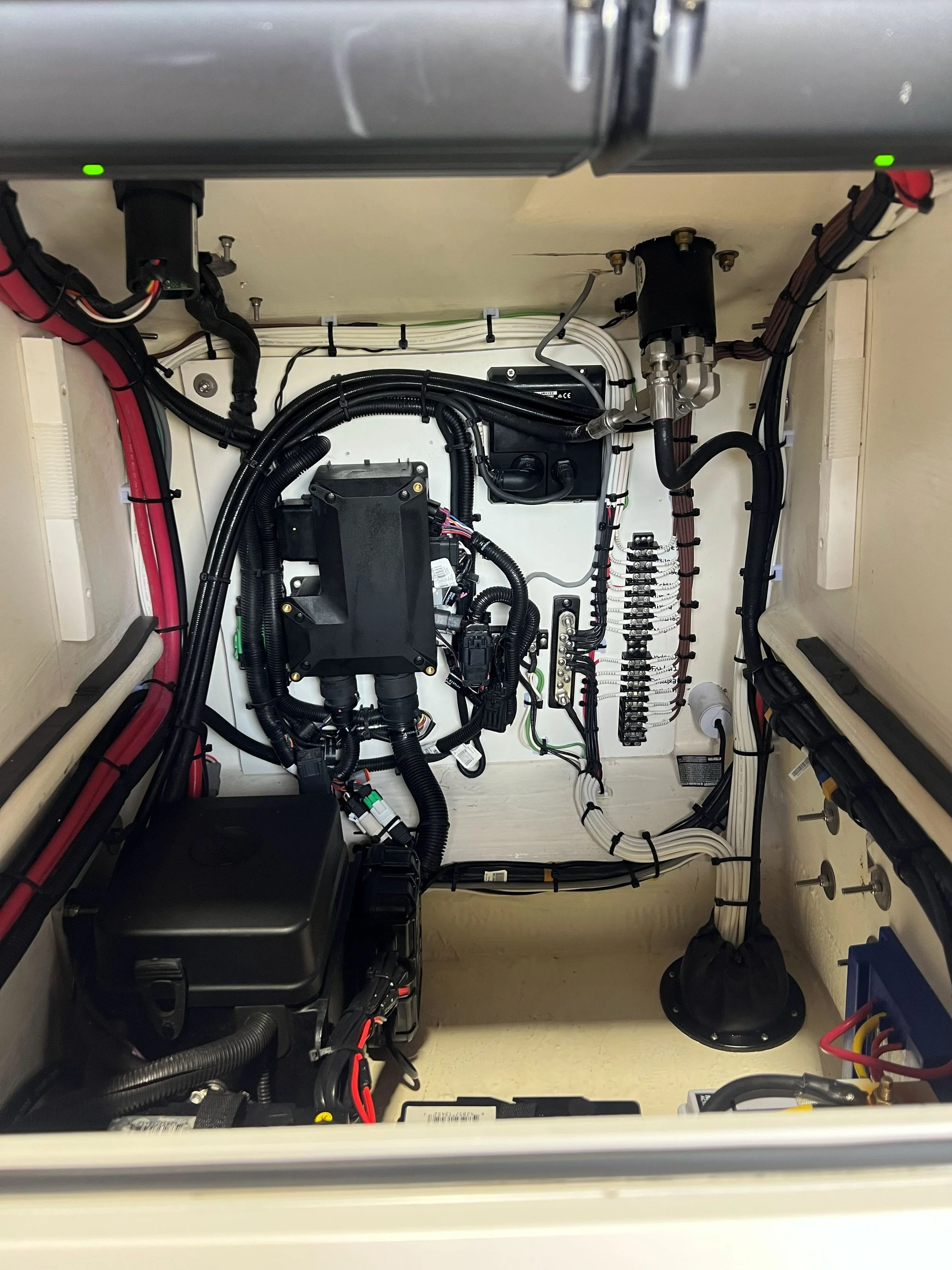 Interior of an electrical control panel with various wires, circuit breakers, and electronic components.