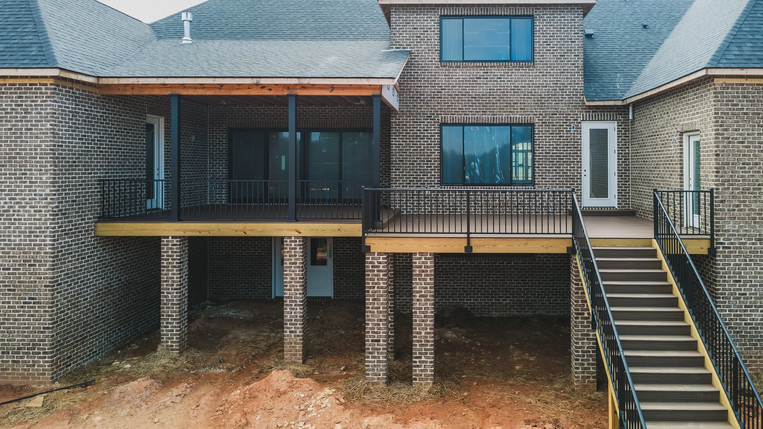 rear view of home and covered and open deck