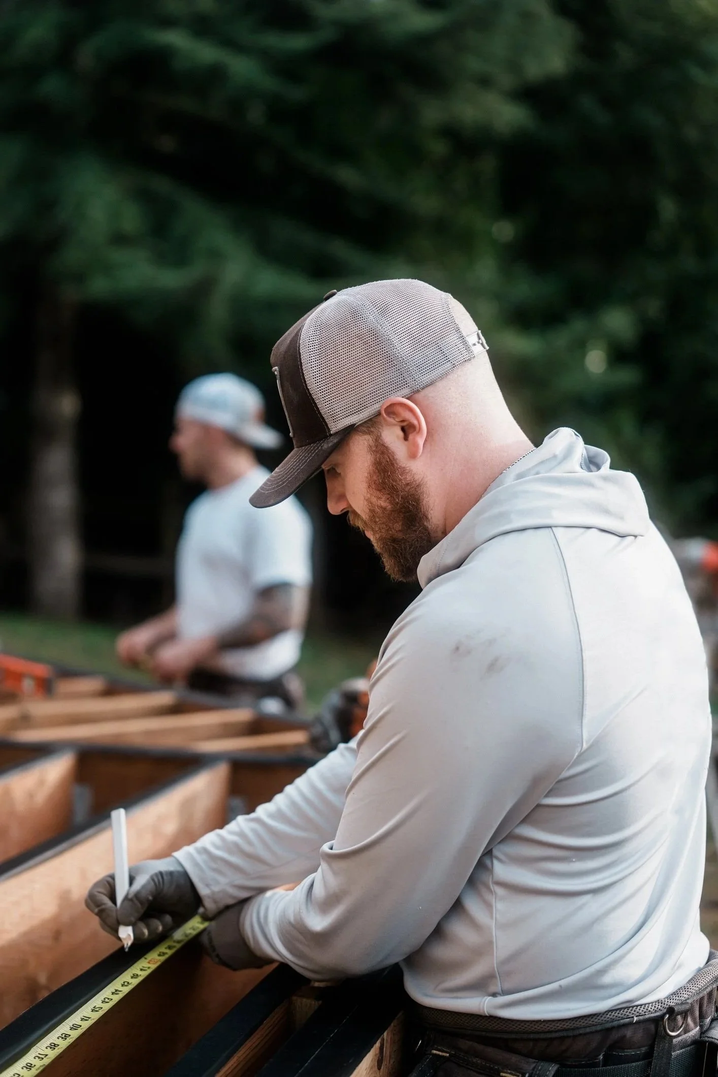 close up on a contractor measuring and building a deck
