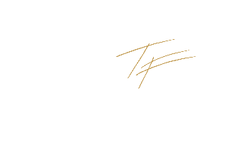 Close-up of a black background with a gold signature or handwriting.