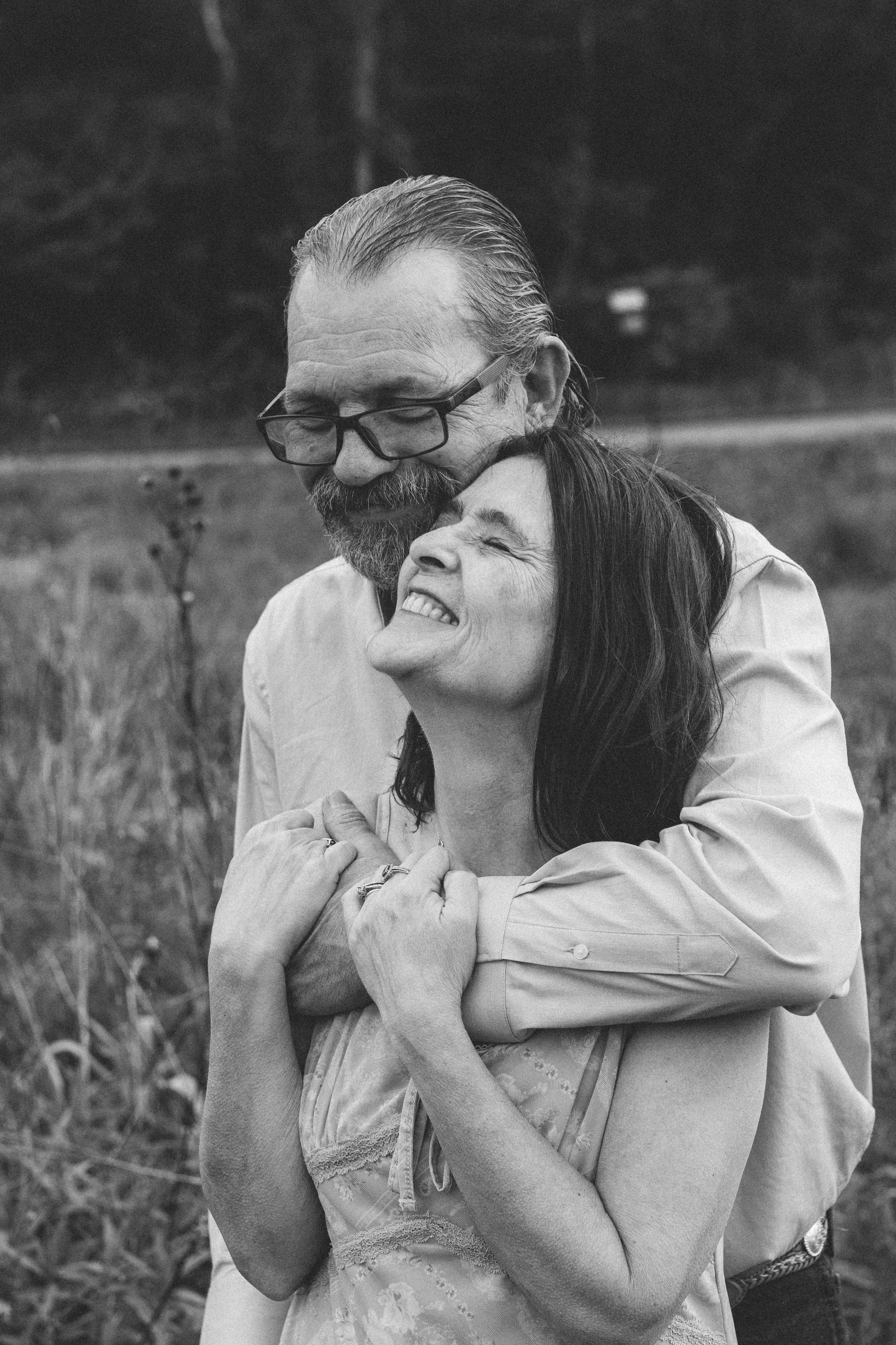 Black and white portrait of an older couple in a natural outdoor setting, timeless elegance