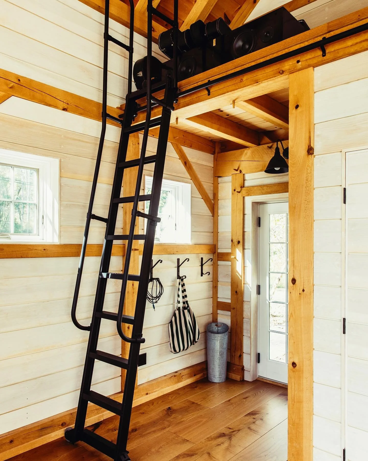 A rolling ladder can be the perfect design feature for a versatile and flexible space. Loving how this one provides access to the mini loft in the Studio Barn project.

Photography by @sashaisrael
Build by @wkt_construction