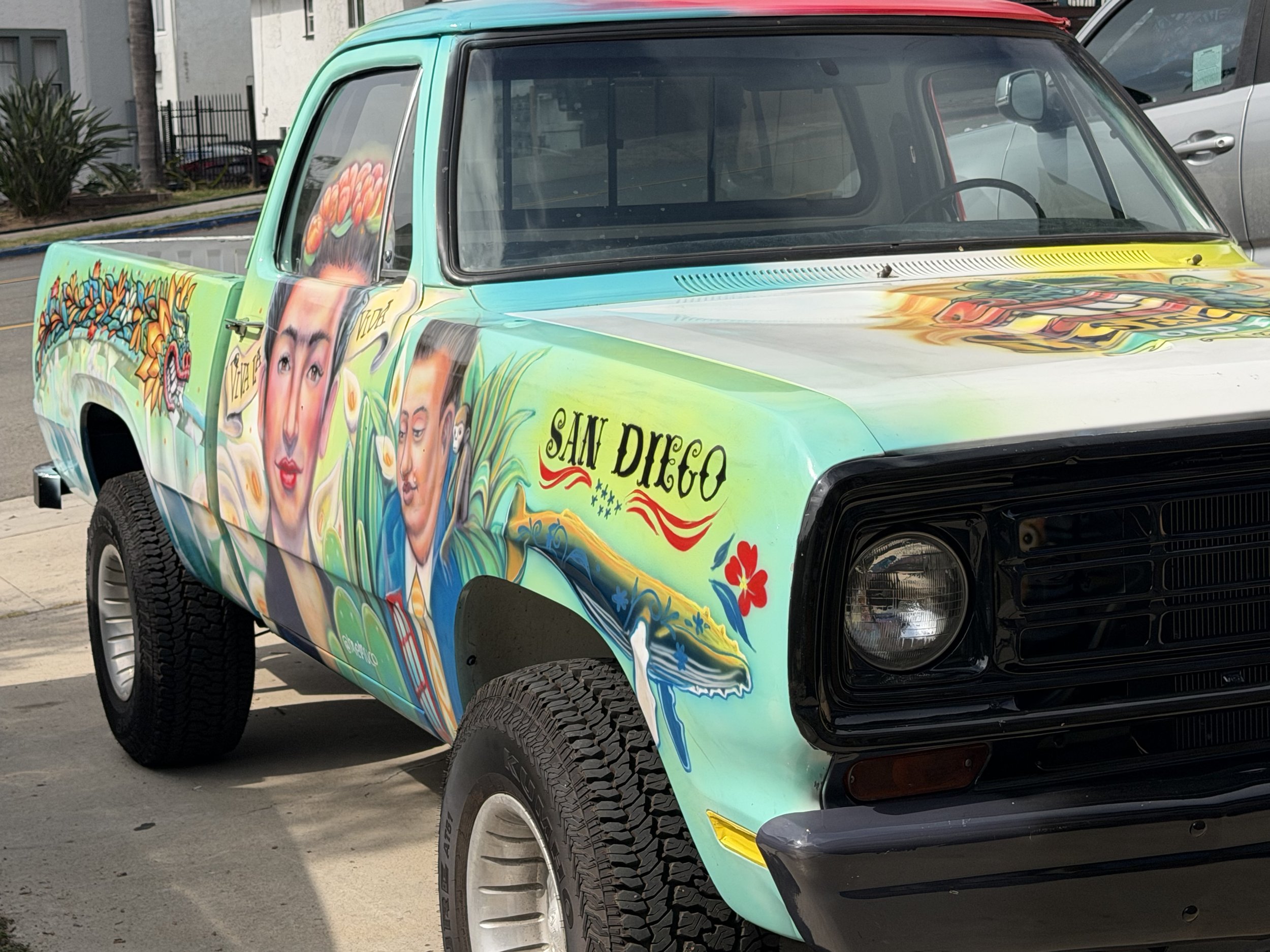 Hand-painted vintage Dodge truck featuring mural artwork by Memuco at La Esquinas in Old Town San Diego.