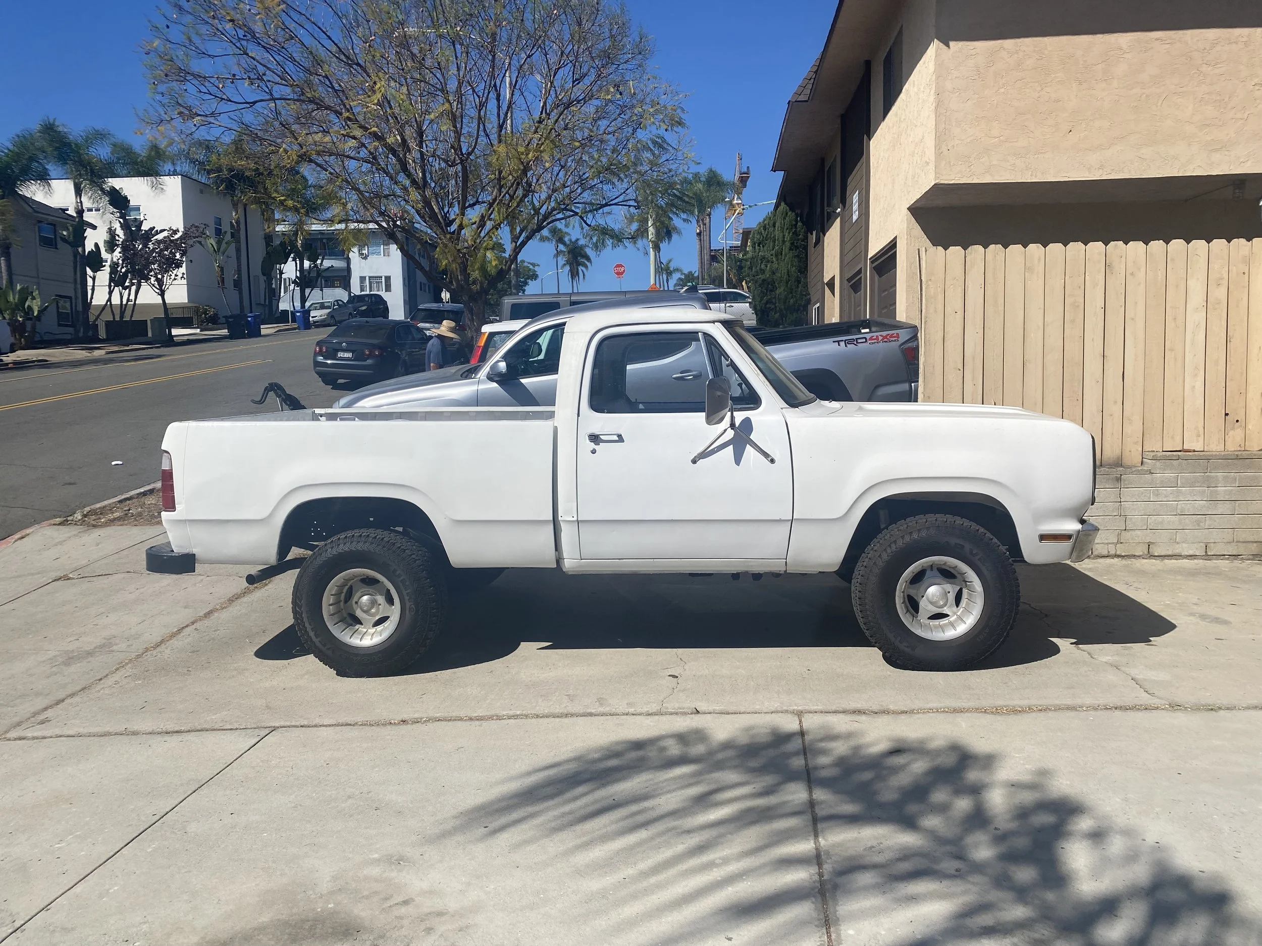 Restored white 1976 Dodge W100 parked in San Diego after completion of major restoration work.
