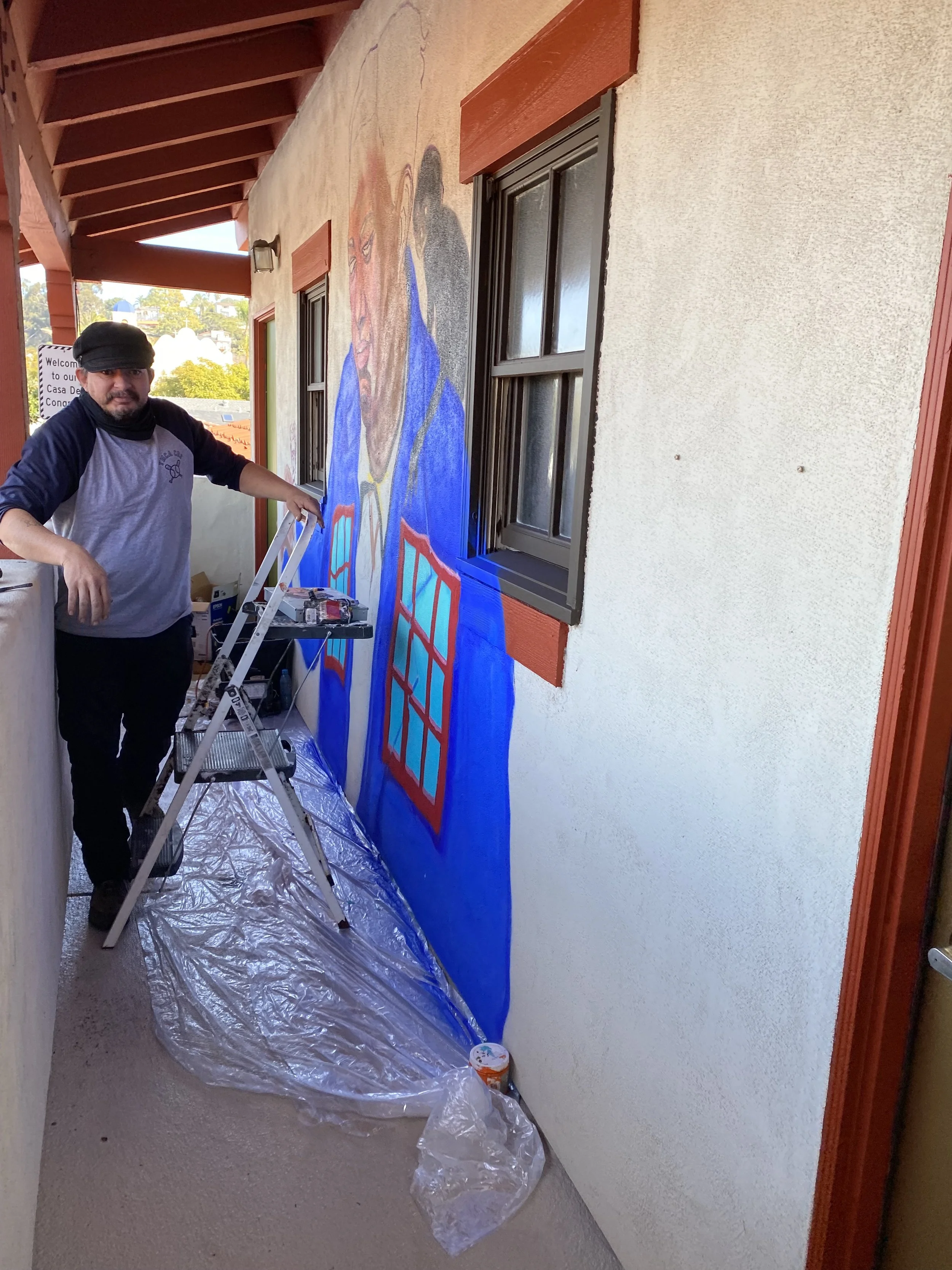 San Diego mural artist Memuco working on a large-scale mural in Old Town San Diego, creator of the five original artworks featured in the La Esquinas Mural Collection.