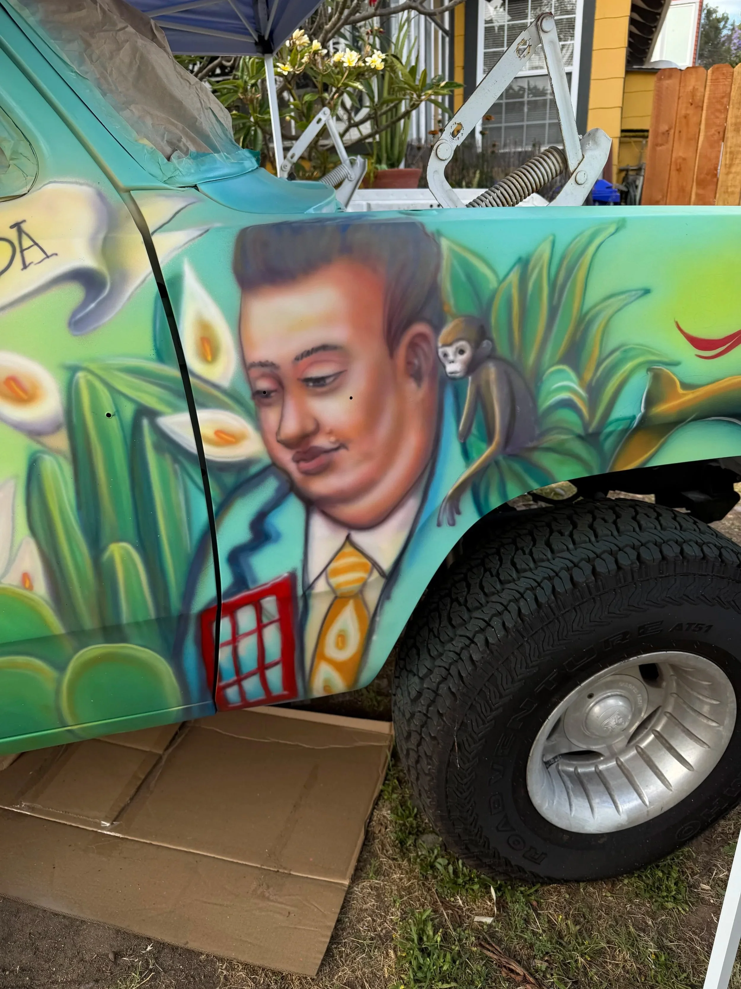 Hand-painted vintage Dodge truck displaying El Muralista artwork by Memuco.