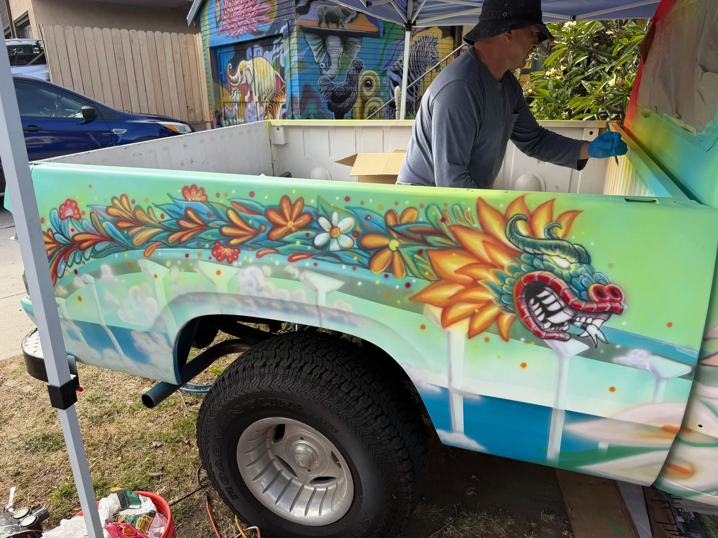 El Dragón Cambiante artwork painted on the side of a vintage Dodge truck by Memuco in Old Town San Diego.