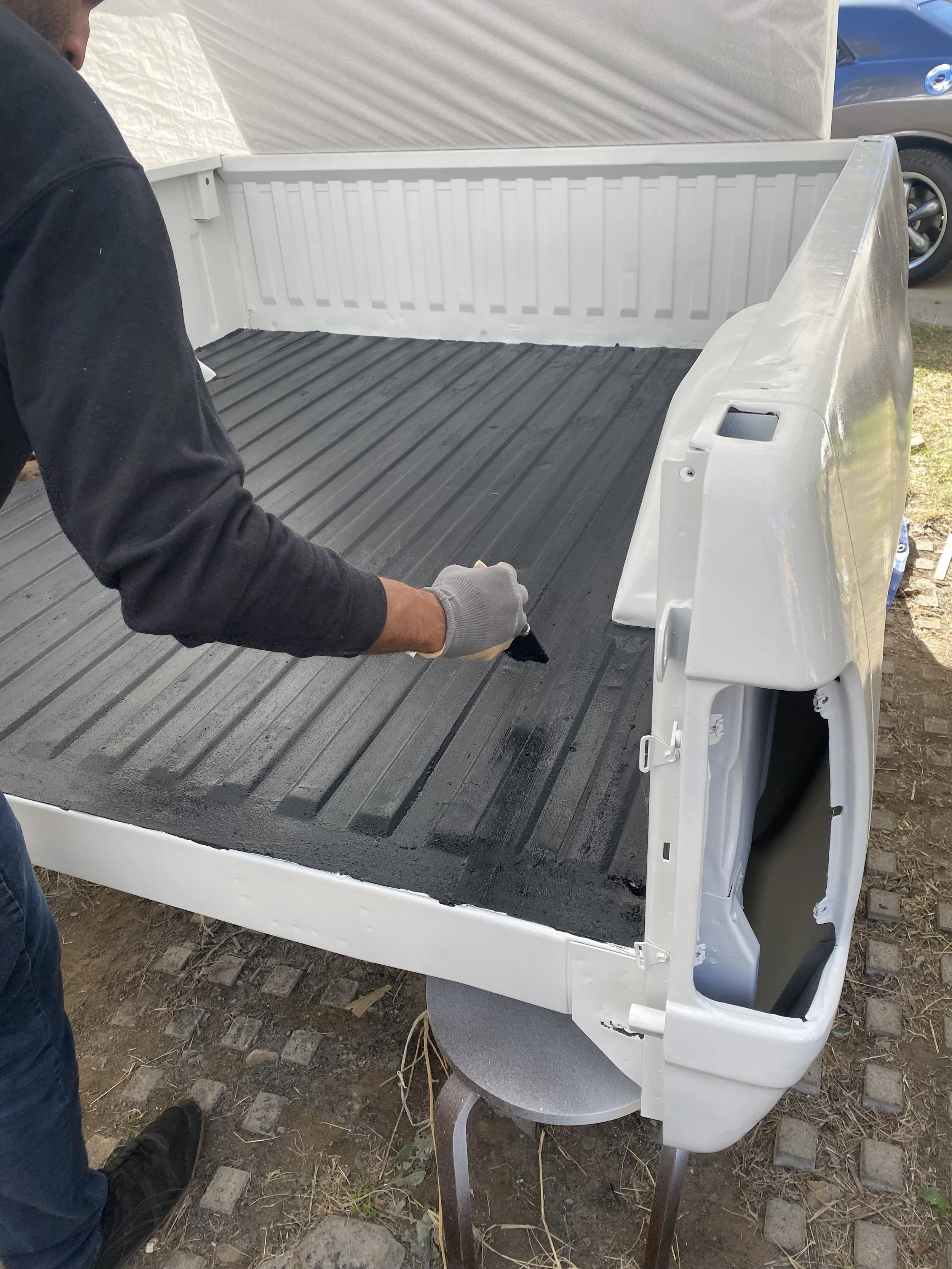 Freshly painted white truck bed being refinished as part of the restoration of Roger the Dodge W100.