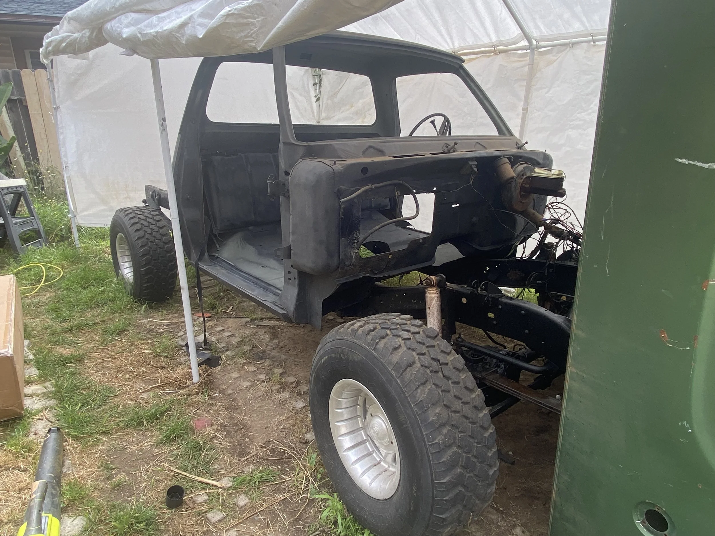 Dodge W100 cab mounted on restored chassis during reconstruction phase of the truck restoration.